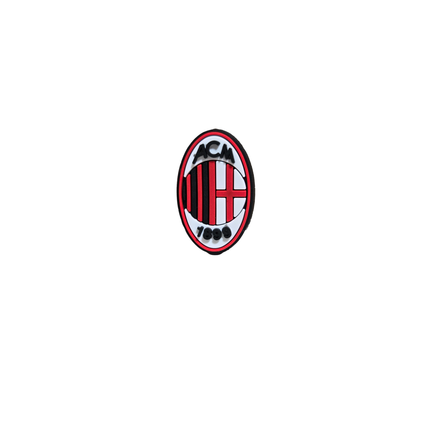 An oval-shaped Soccer Croc Charm featuring the AC Milan crest with red and black stripes, a red cross, and "ACM 1899" text on a black background.