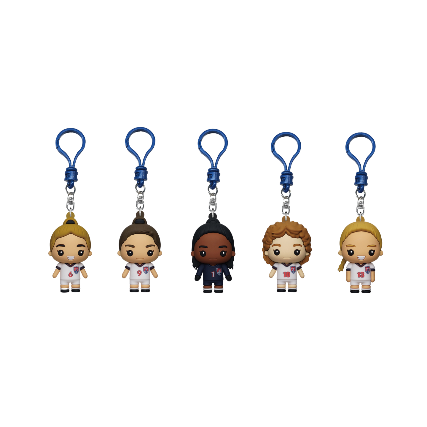 A Monogram 99ers 1999 Womens World Cup Champions 5 Piece Bag Clip Set featuring five stylized, cartoon-like figurines of soccer players in US jerseys. Each figure is hanging from a blue plastic clip and represents a different player with jersey numbers 6,