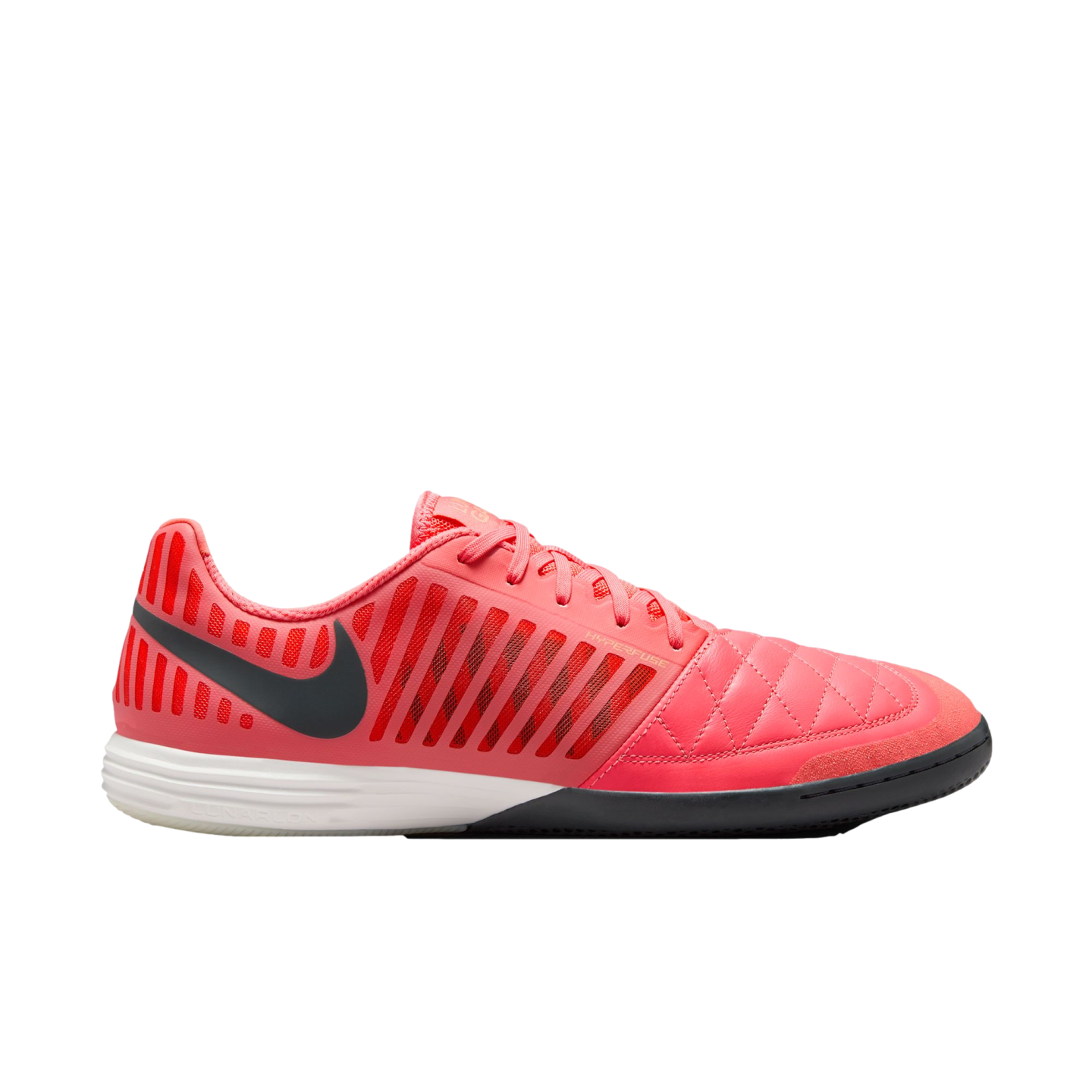 A pink Nike indoor soccer shoe shown from a side profile with a black swoosh, white midsole, and a textured upper.