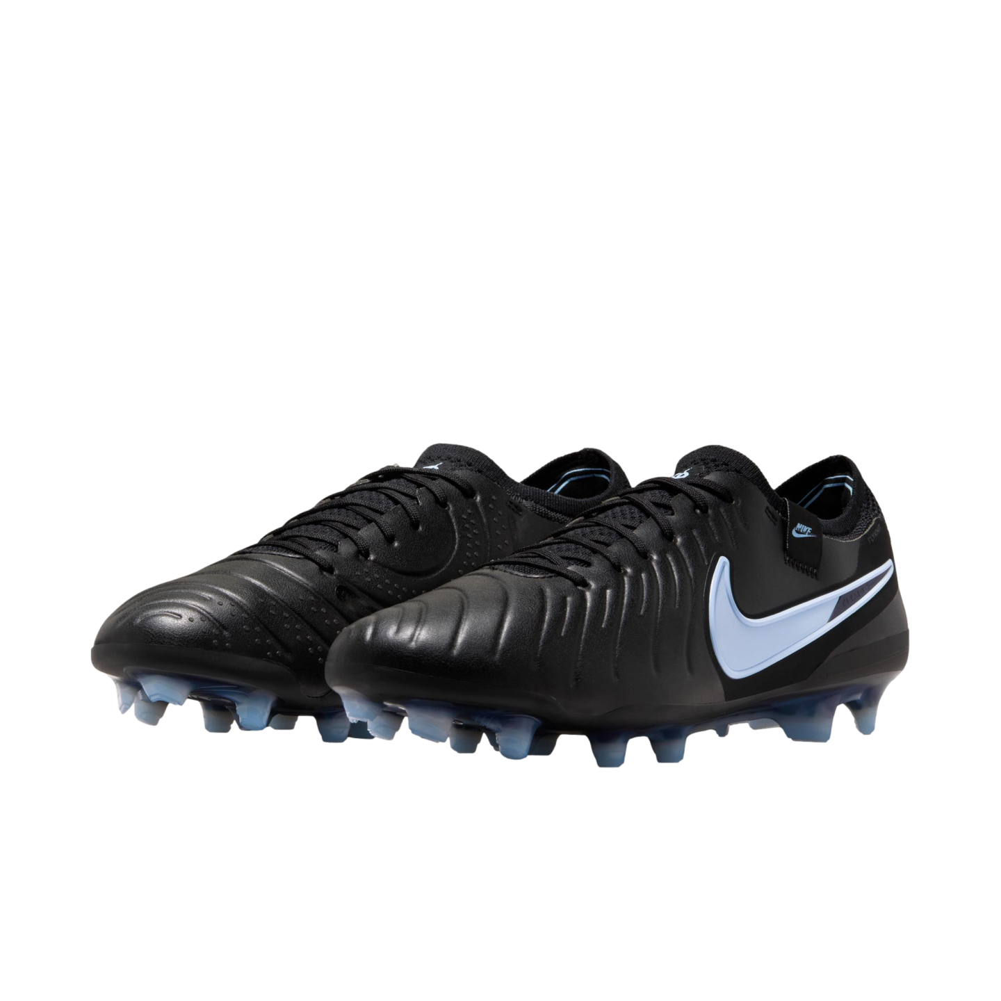 A pair of black Nike soccer cleats featuring a light blue swoosh and translucent blue studs, presented against a solid black background.