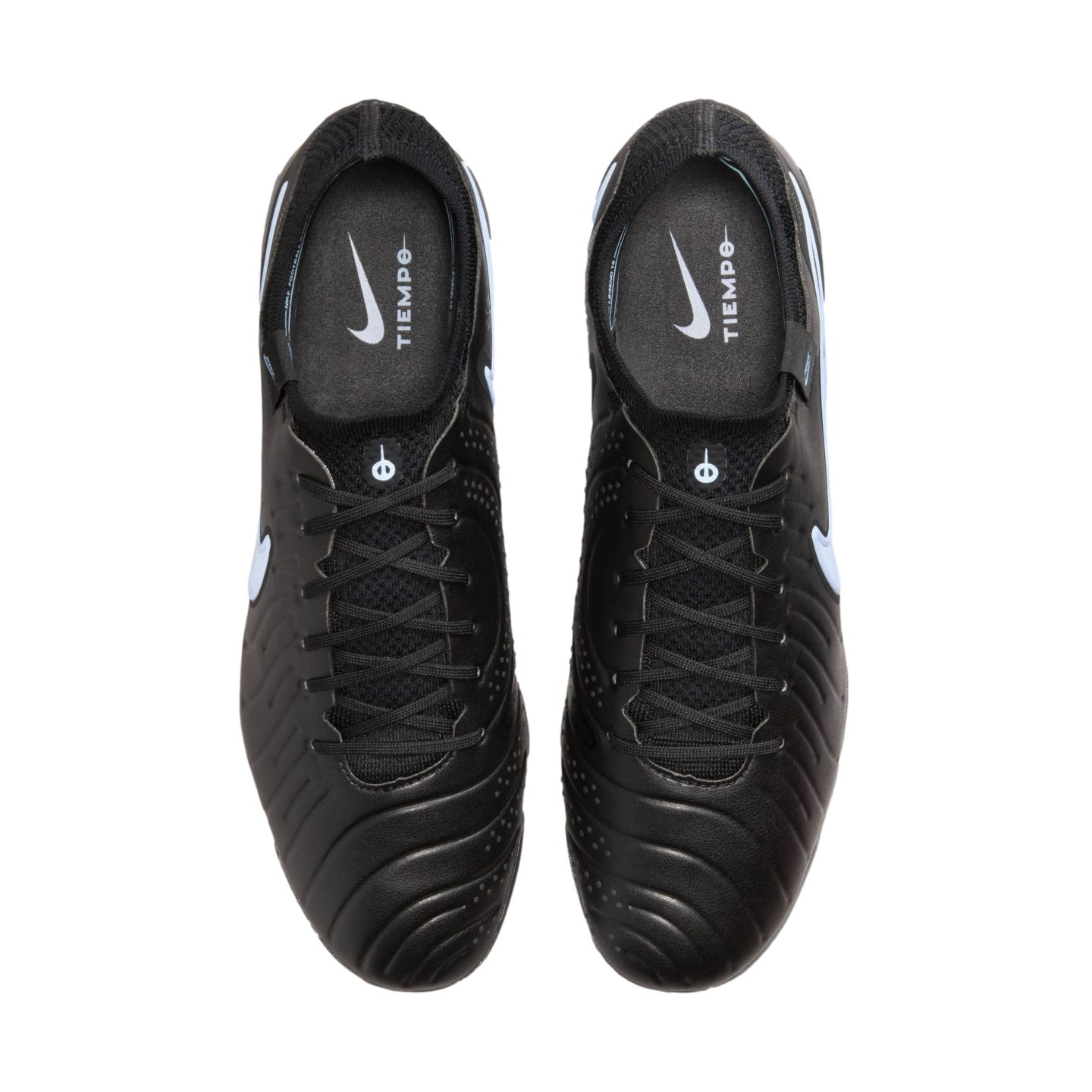 Top-down view of a pair of black Nike Tiempo soccer cleats with white accents on a solid black background.