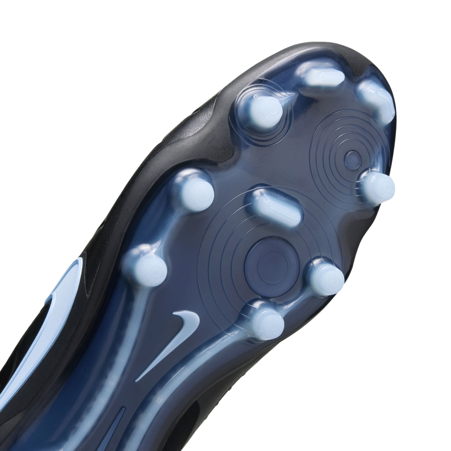 Close-up of a black Nike soccer cleat sole with light blue studs and a white swoosh on a translucent blue base.