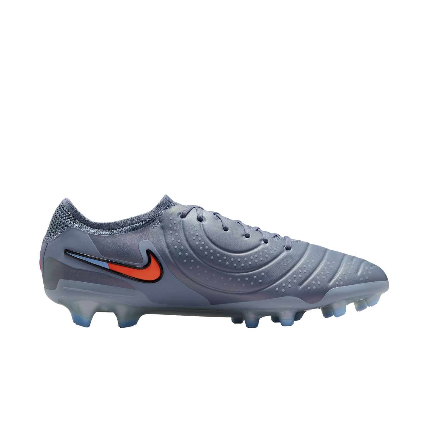 Profile view of a grey Nike soccer cleat featuring a textured upper, an orange and blue swoosh, and translucent blue studs, set against a solid black background.