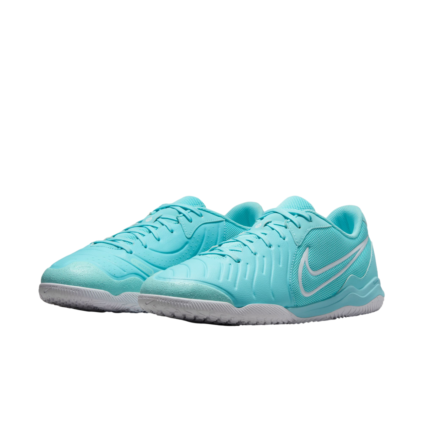 A pair of teal Nike indoor soccer shoes with white soles and a white Swoosh outline, set against a white background.