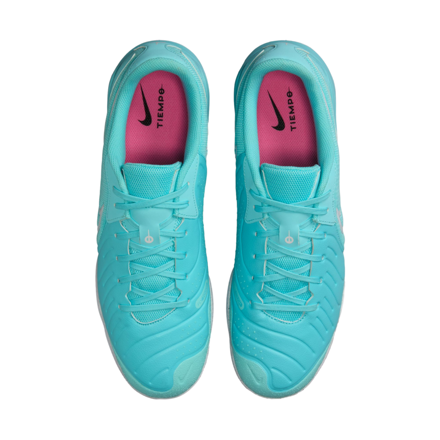 Top-down view of a pair of bright turquoise Nike Tiempo soccer shoes with pink insoles and matching turquoise laces.
