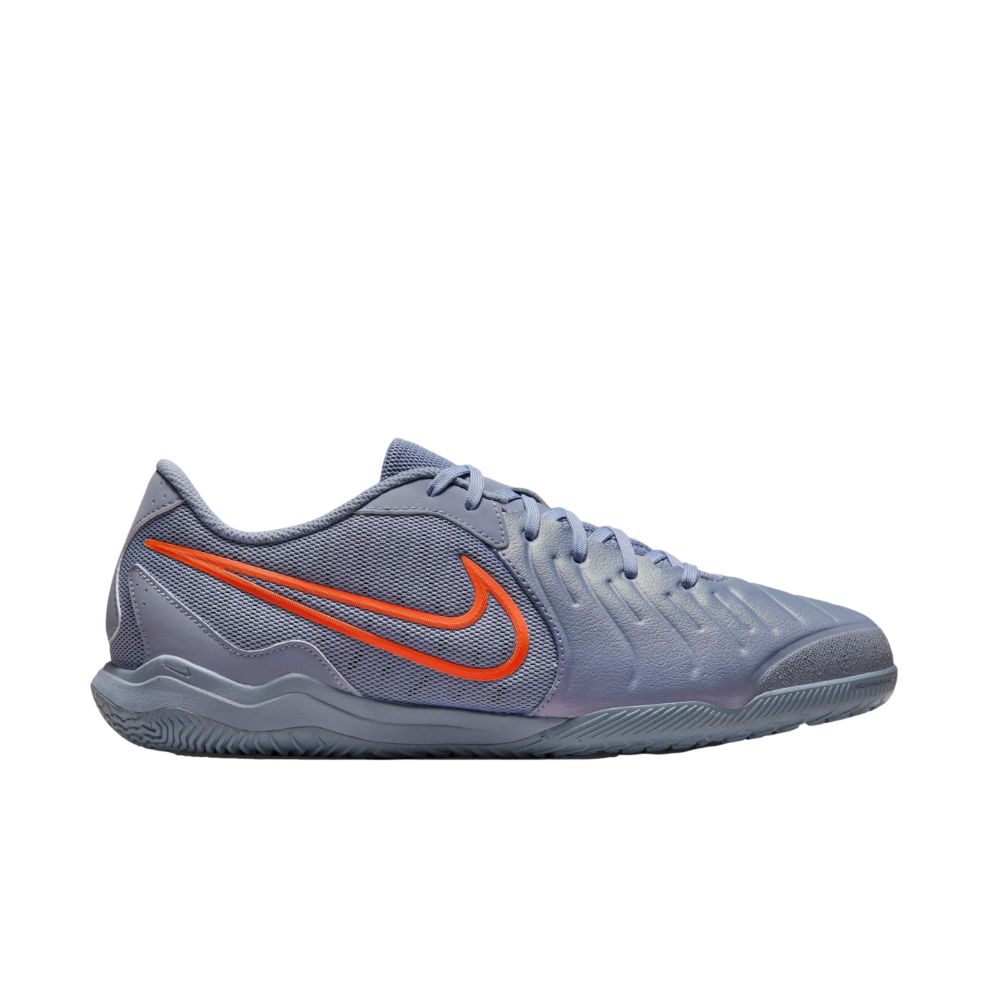 A side profile of a light purple Nike indoor soccer shoe with a bright orange swoosh logo, shown against a black background.