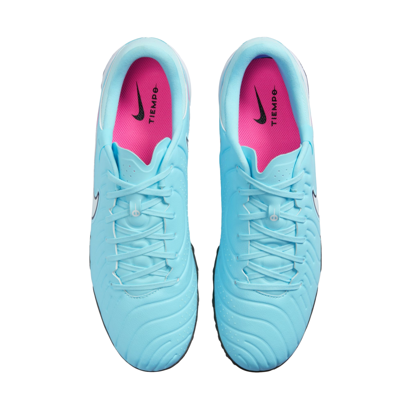 Top-down view of light blue Nike Tiempo soccer shoes with vibrant pink insoles and blue laces on a white background.