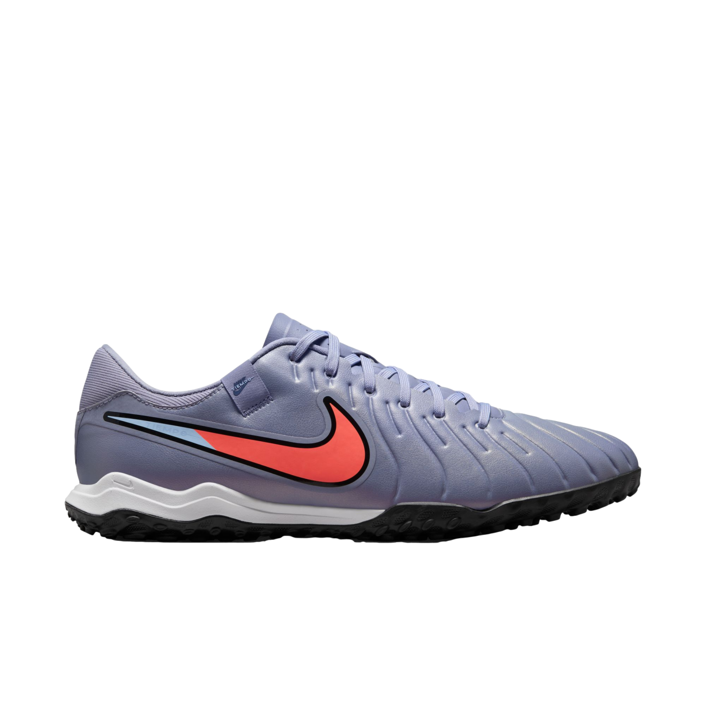 Profile view of a lavender Nike soccer turf shoe featuring a vibrant red-orange swoosh, white wavy midsole, and black rubber outsole against a dark background.