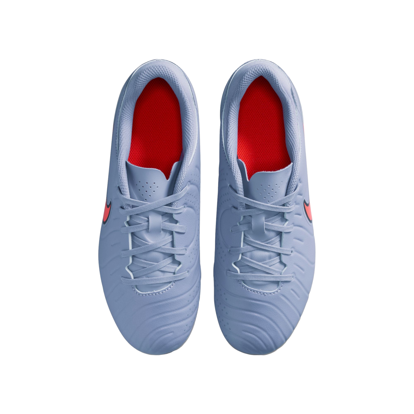 Top-down view of light blue Nike soccer cleats with red interior lining and red logos, set against a solid black background.