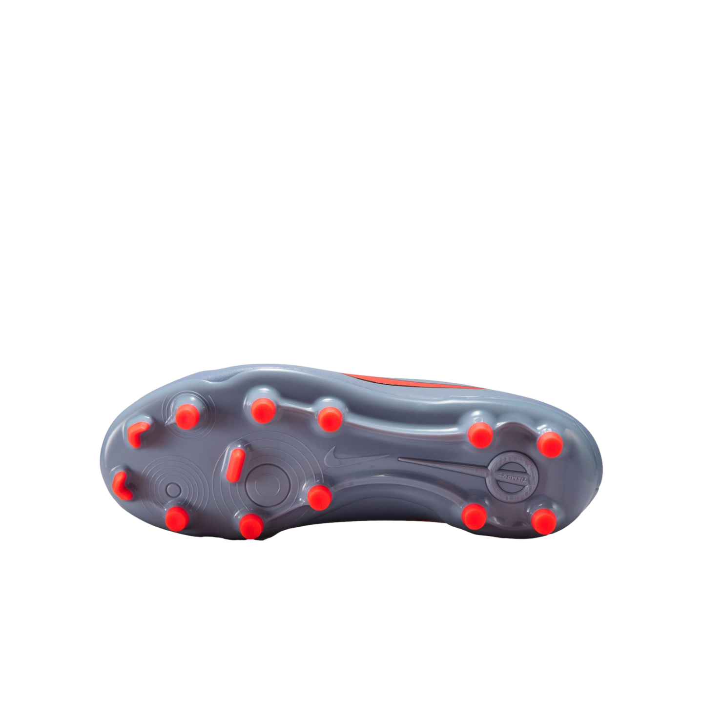 Bottom view of a grey Nike soccer cleat featuring thirteen bright orange studs, set against a solid black background.