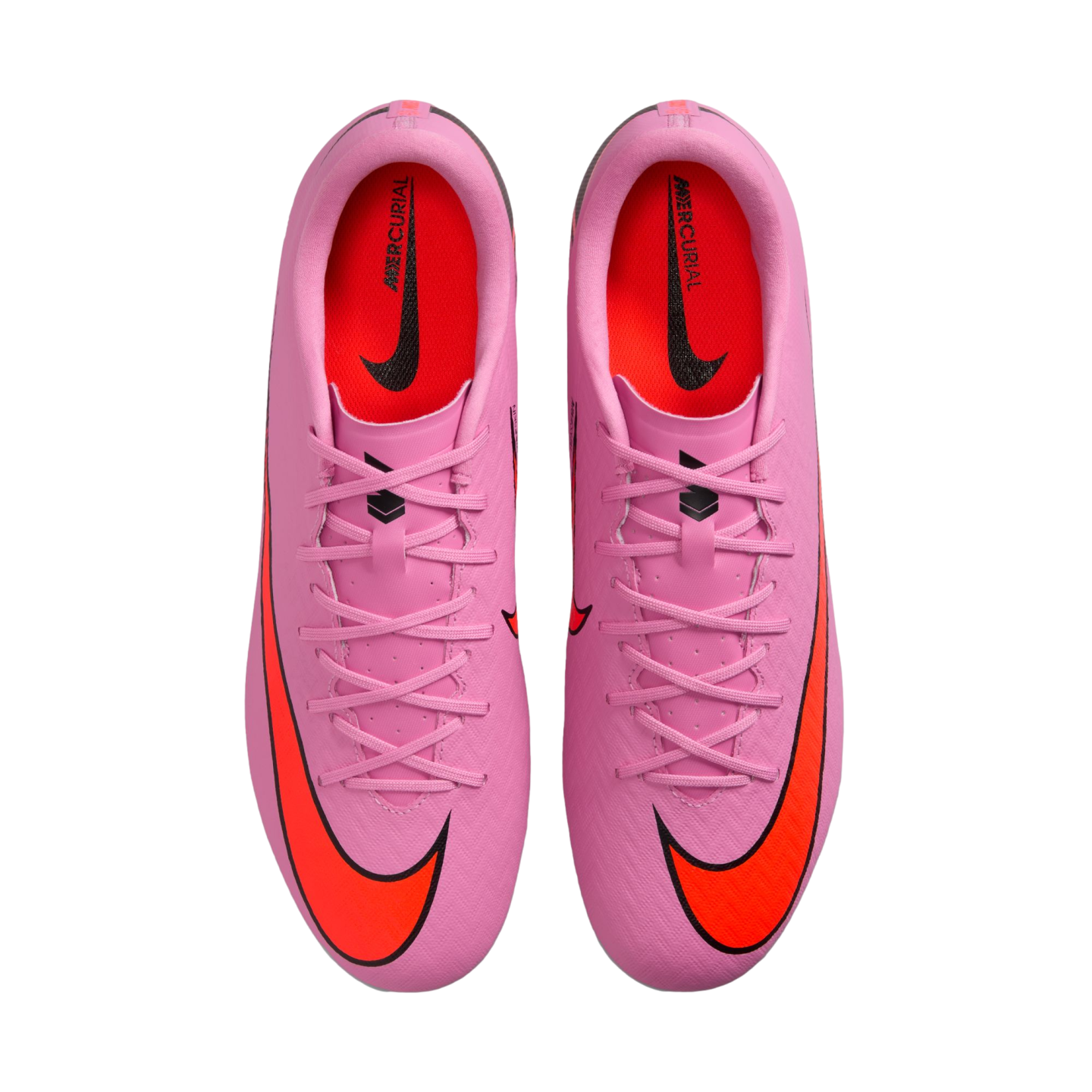 Top-down view of pink Nike Mercurial soccer cleats with orange swooshes and red insoles, centered against a black background.