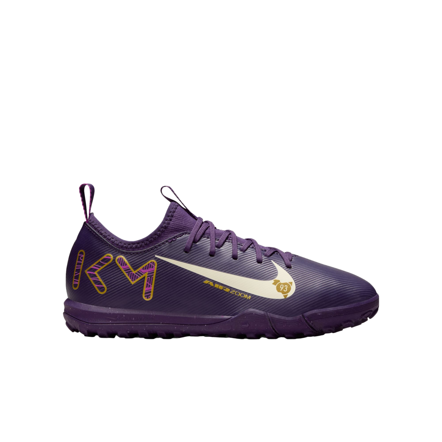 Side profile of a purple Nike soccer turf shoe featuring a white Swoosh, gold "KM" branding on the heel, and "AIR ZOOM" text.