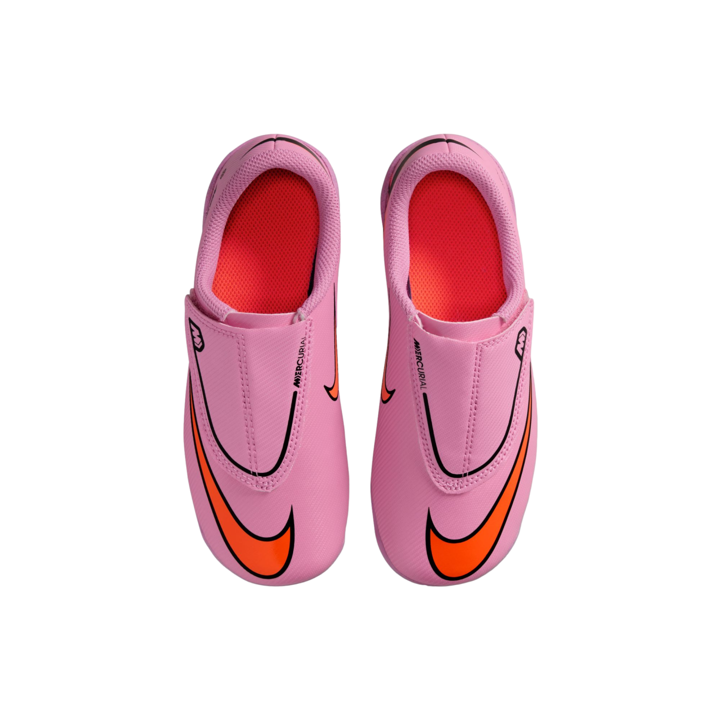 Top-down view of a pair of pink Nike Mercurial soccer cleats with bright orange swooshes and red inner linings against a black background.