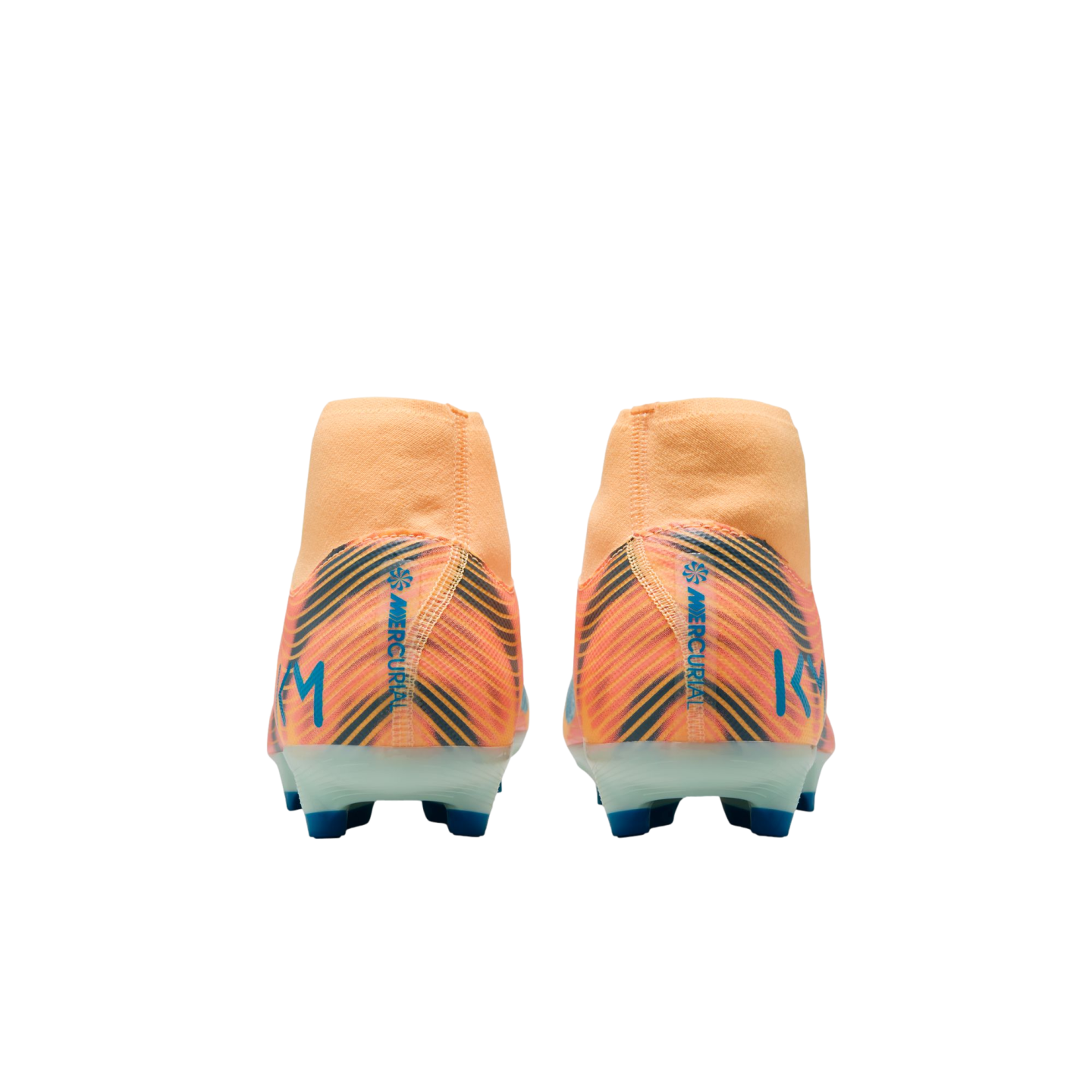 Back view of two orange Nike Mercurial KM soccer cleats with blue and black diagonal patterns and blue studs against a black background.