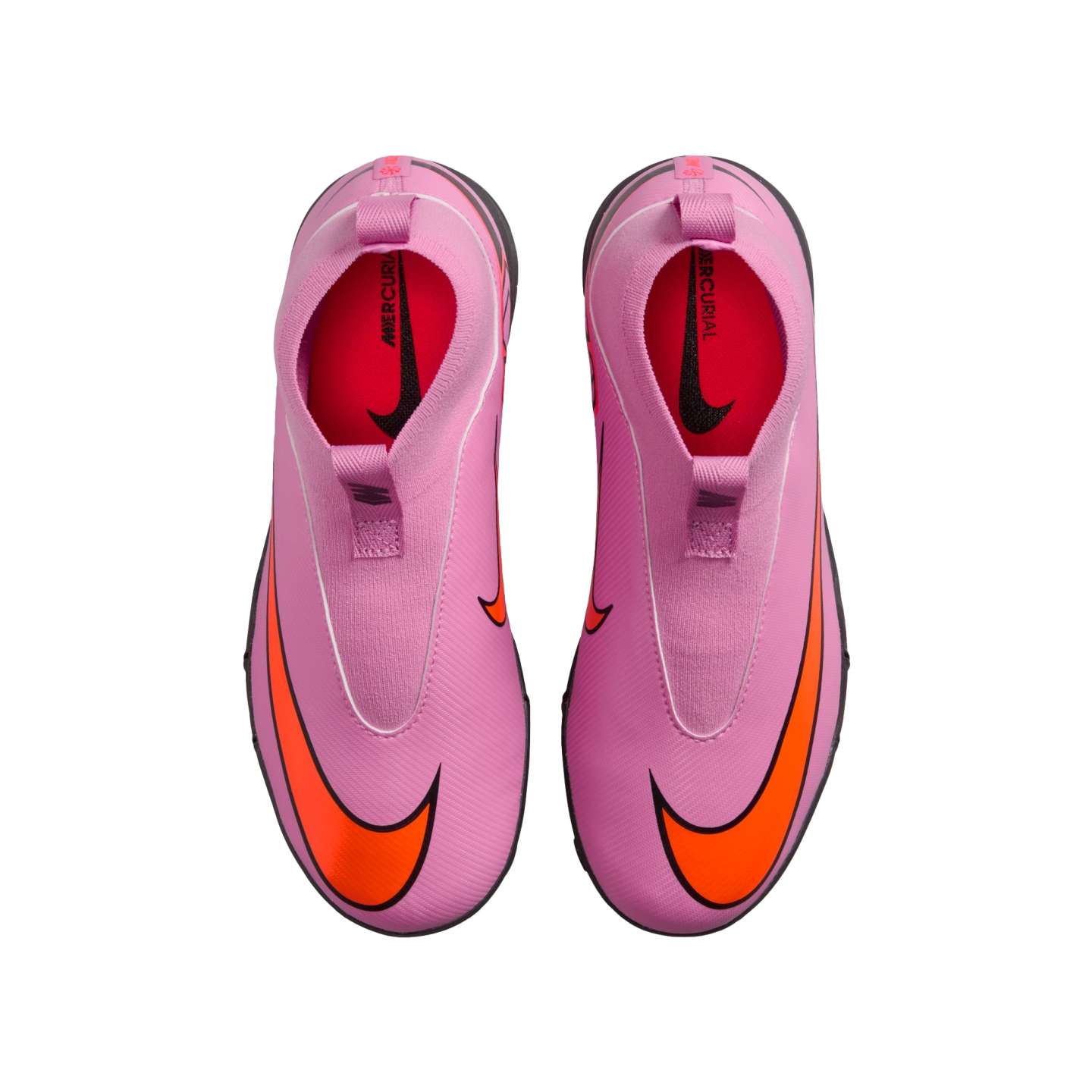 Top-down view of a pair of bright pink laceless Nike Mercurial soccer shoes with large orange swooshes against a solid black background.