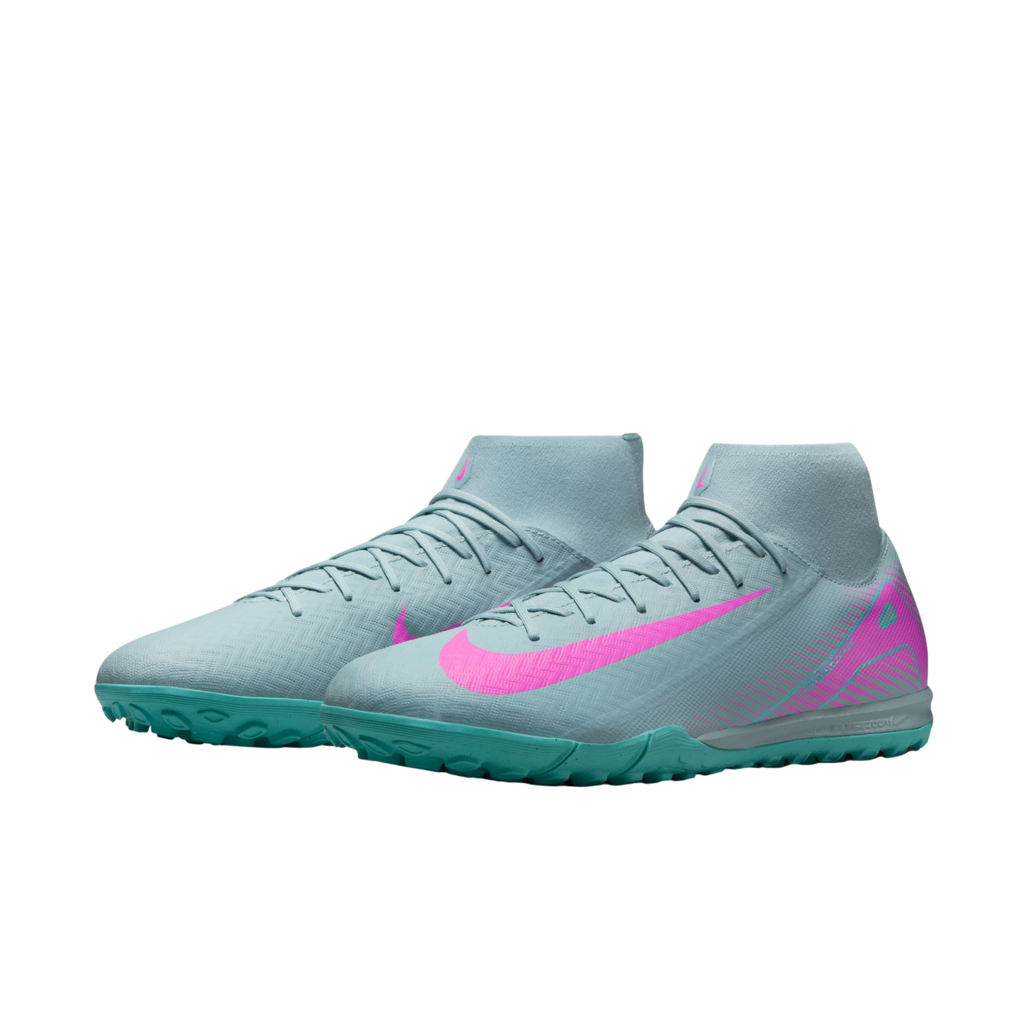 A pair of light blue Nike high-top turf soccer shoes with bright pink Nike swooshes and teal soles, against a white background.