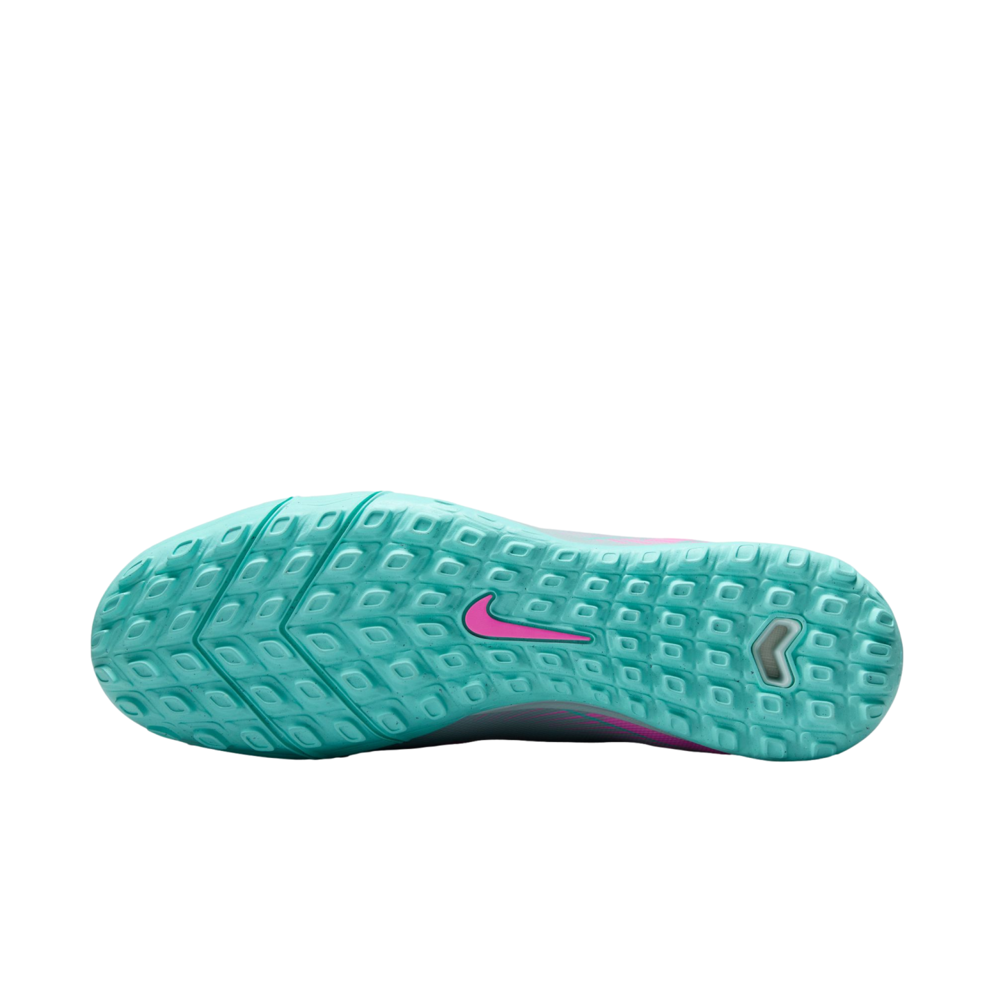 Bottom view of a light teal Nike turf soccer shoe featuring a pink swoosh logo and a textured grid outsole for traction on turf surfaces.