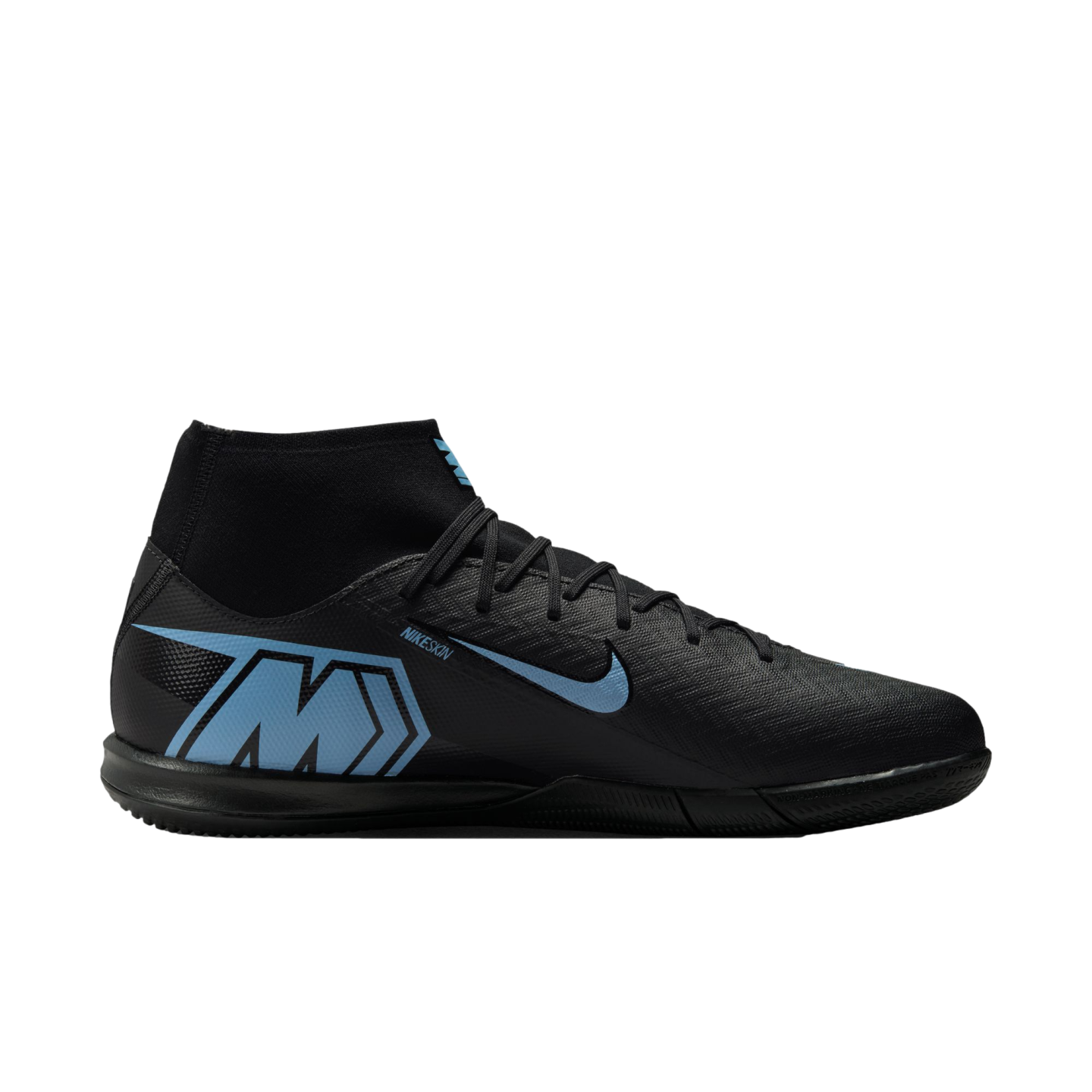 Profile of a black Nike Mercurial indoor soccer shoe with light blue accents, including a large "M" logo on the heel and a blue swoosh, set against a black background.