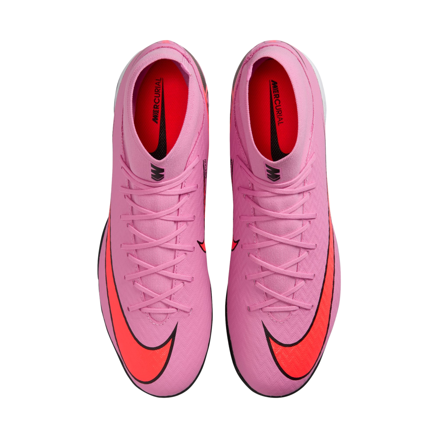 Top-down view of a pair of bright pink Nike Mercurial soccer cleats with vibrant orange swooshes on a black background.