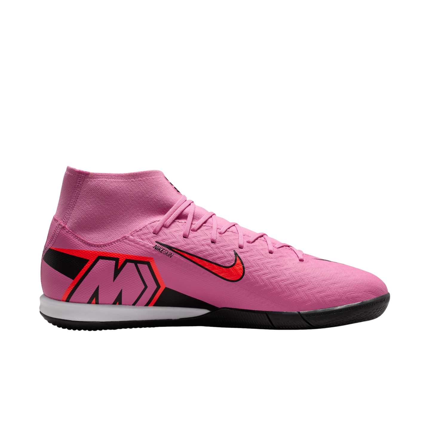 A pink Nike indoor soccer shoe with a high-top sock collar, red Nike swoosh, and large "M" on the heel, shown in profile against a black background.