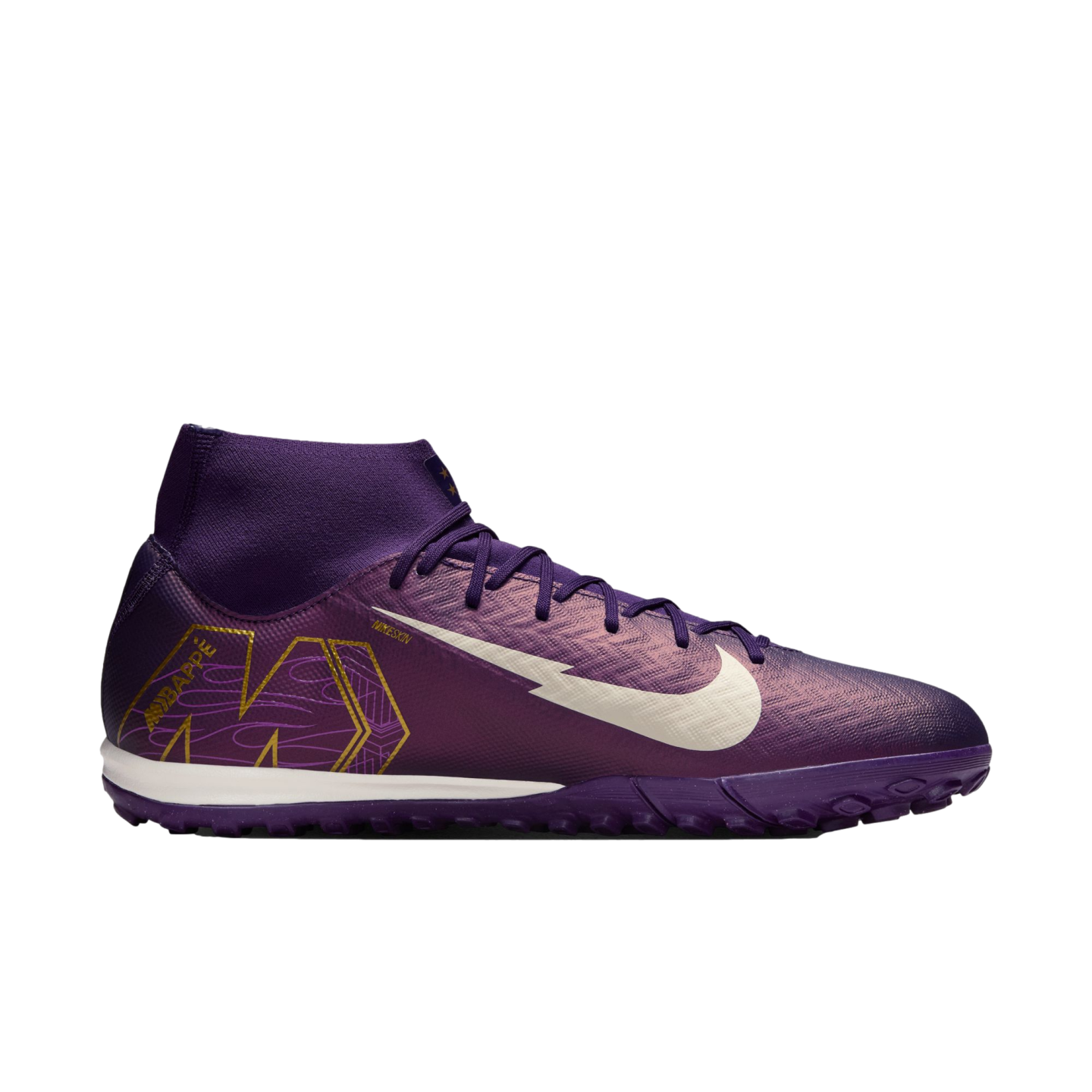 Side view of a purple Nike Mercurial turf soccer shoe with a white swoosh and gold Mbappé branding. It features a high collar and a textured purple upper.