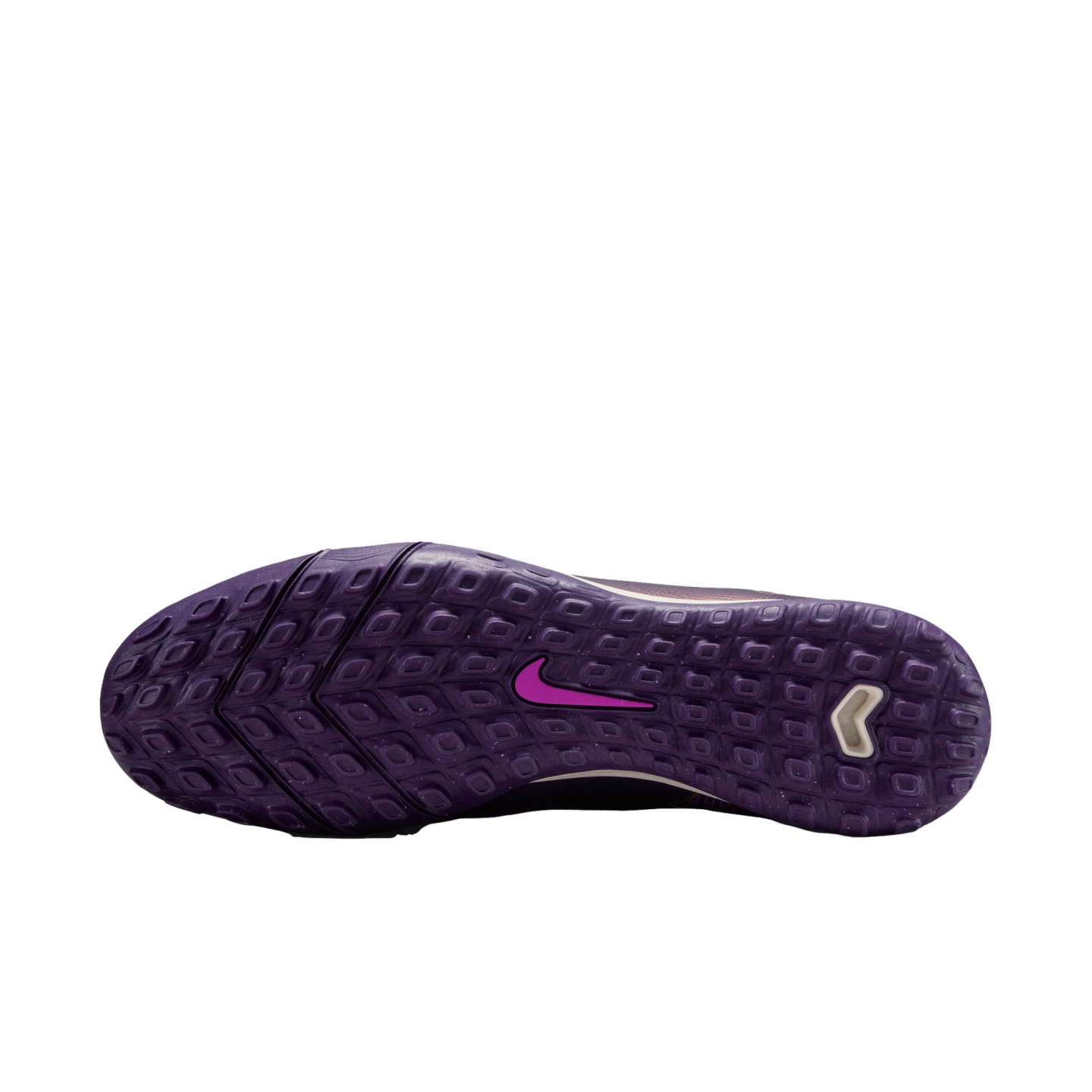 The bottom of a purple Nike turf shoe features a textured purple rubber outsole with a pink Nike swoosh and a white chevron-shaped logo near the heel.