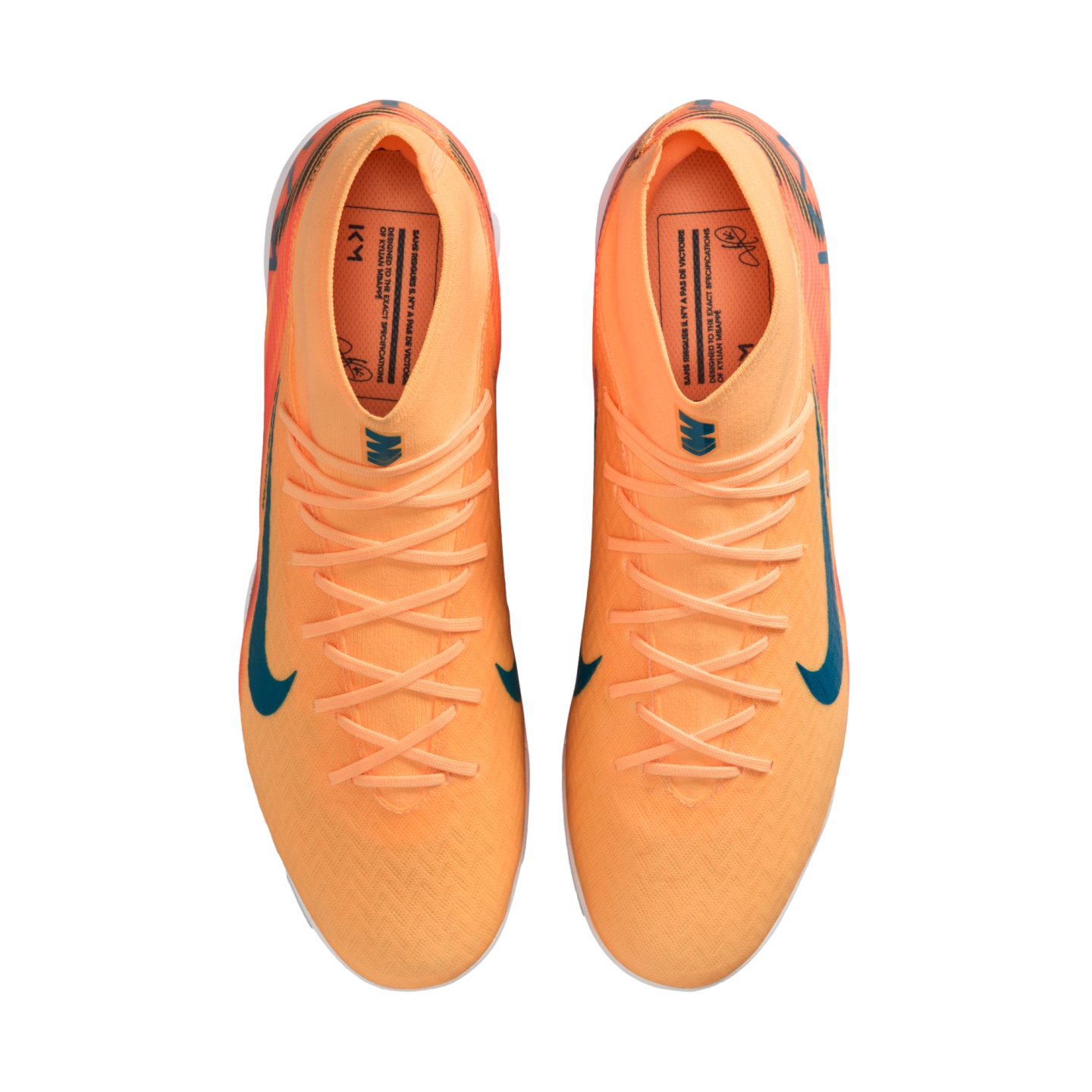 Top-down view of a pair of bright orange Nike soccer cleats with teal swooshes and laces, isolated on a black background.