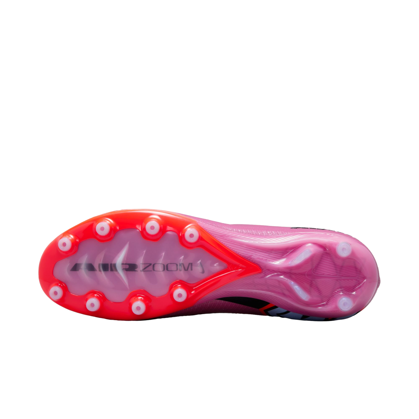 The soleplate of a pink Nike Air Zoom soccer cleat with red accents and white circular studs against a black background.