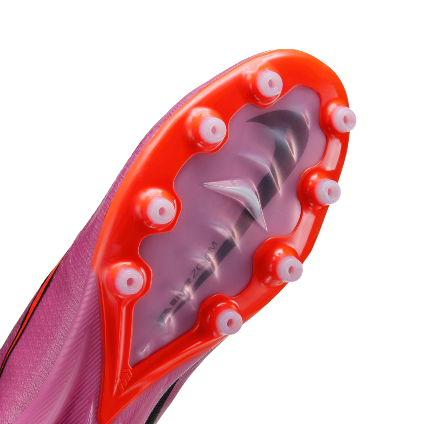 Bottom of a pink Nike soccer cleat showing an orange sole plate with translucent studs and the "Air Zoom" logo visible through the center of the plate.