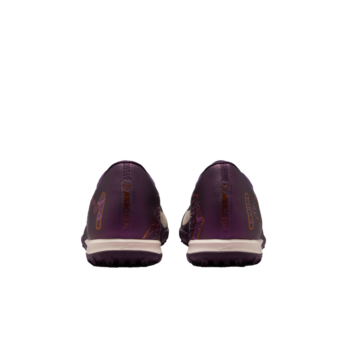 Rear view of a pair of dark purple soccer turf shoes with "MERCURIAL" printed on the heels, featuring cream midsoles and set against a plain white background.