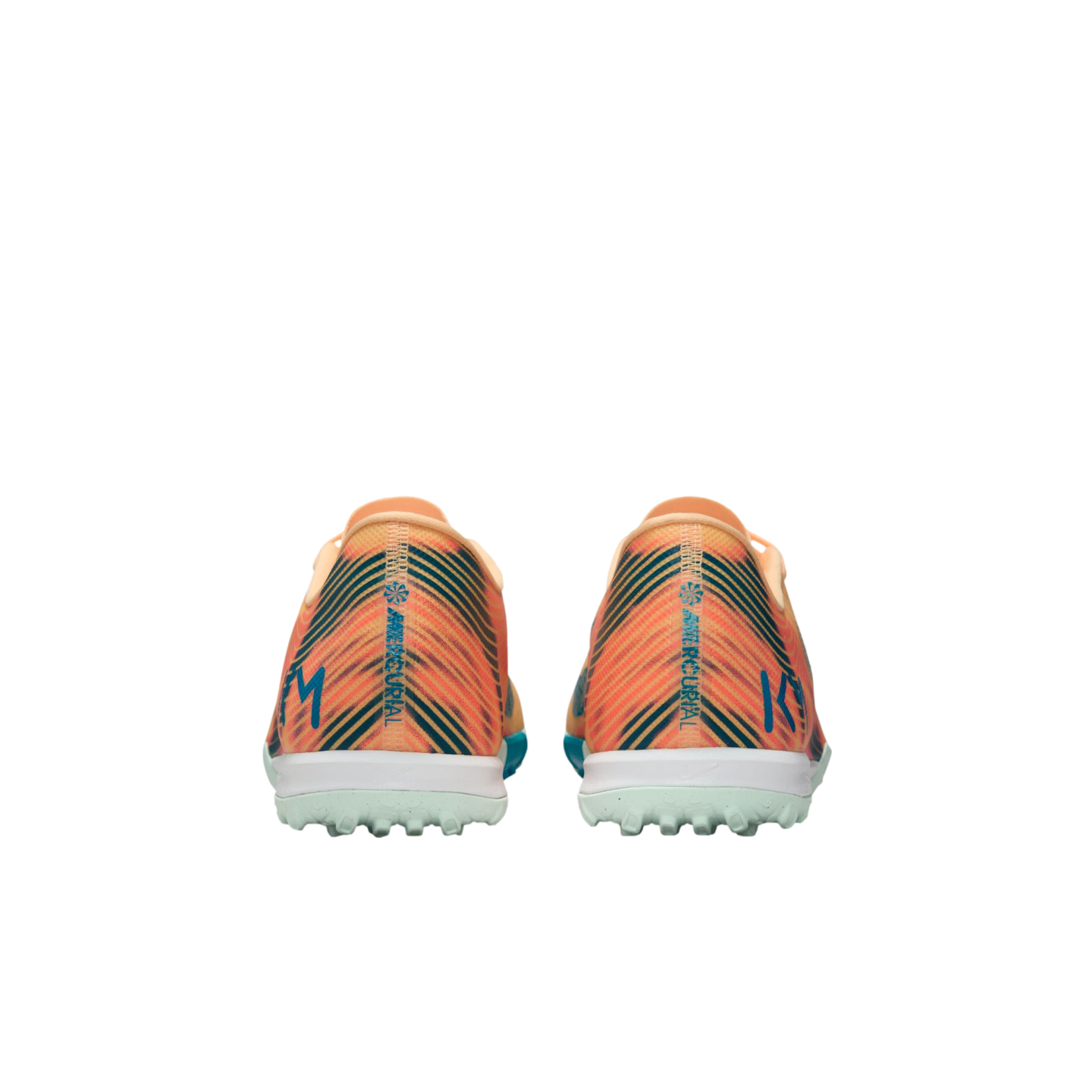 Rear view of orange and teal striped Nike Mercurial turf soccer shoes with "KM" initials on the heels against a black background.