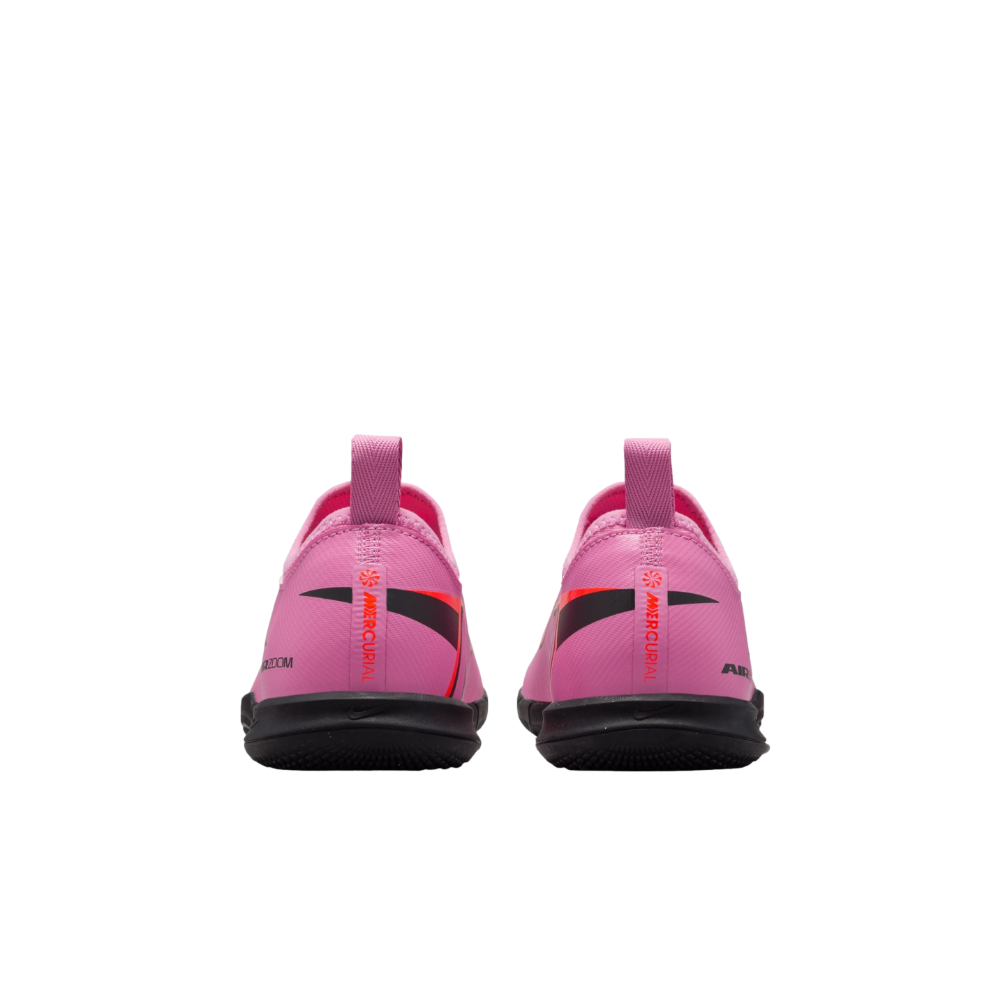 Rear view of a pair of pink Nike Mercurial indoor soccer shoes with black soles and heel pull tabs, set against a black background.