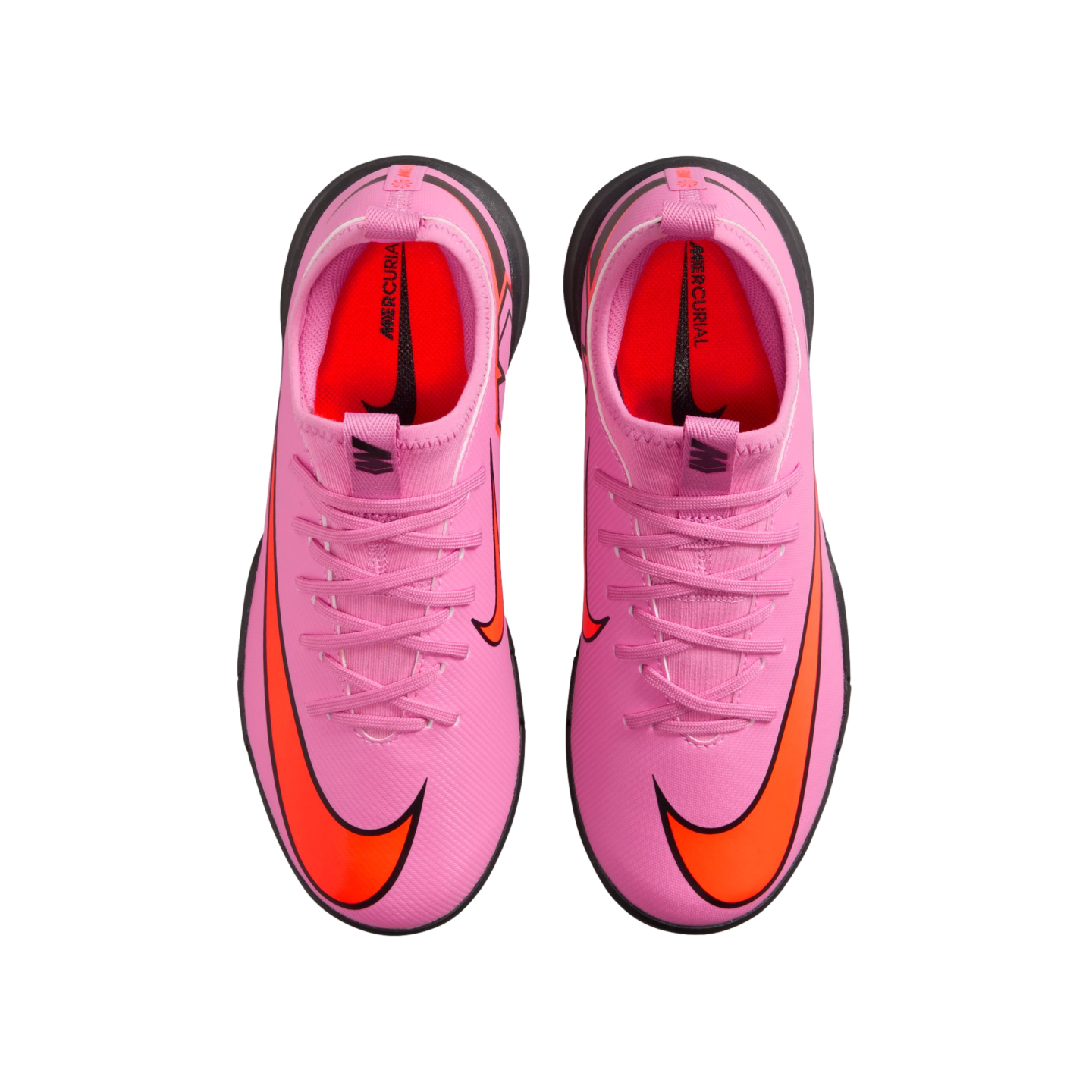 Top-down view of bright pink Nike Mercurial soccer shoes with orange swooshes and black soles against a solid black background.