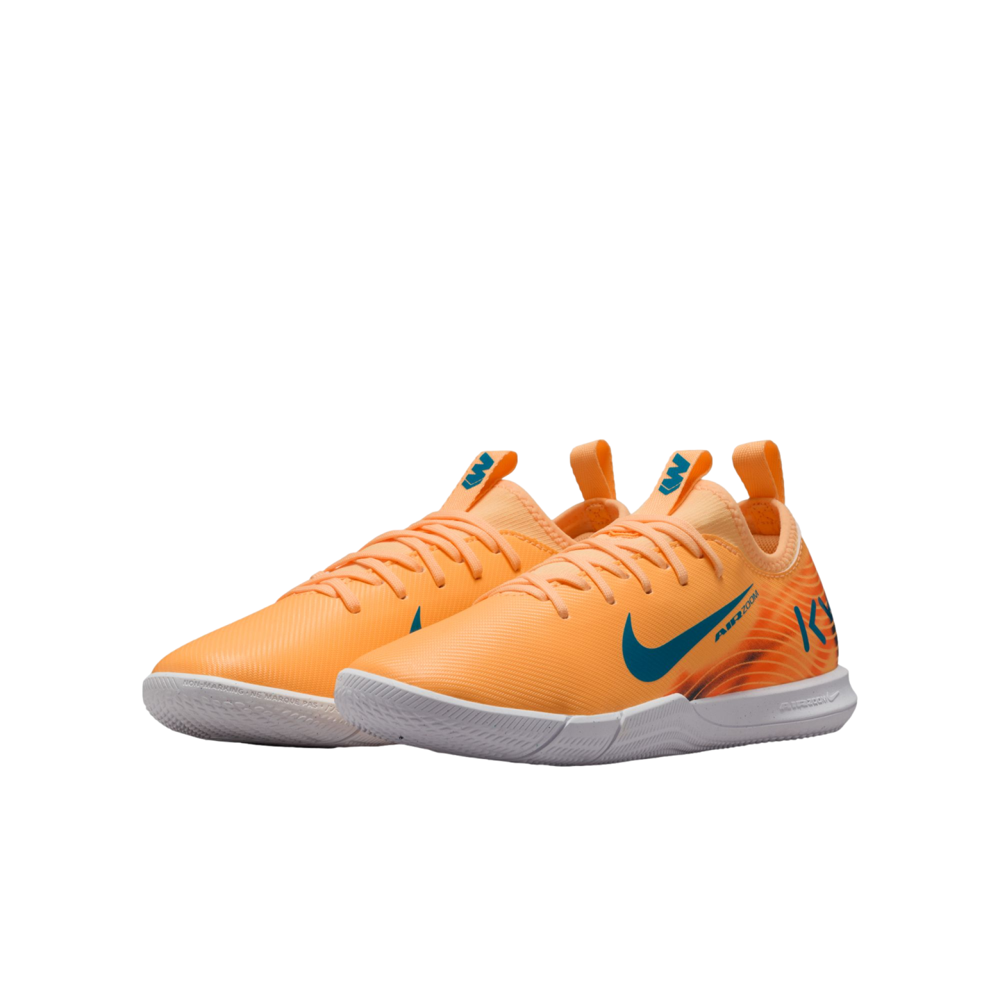 A pair of bright orange Nike Air Zoom indoor soccer shoes with blue swoosh logos and white soles, set against a solid black background.