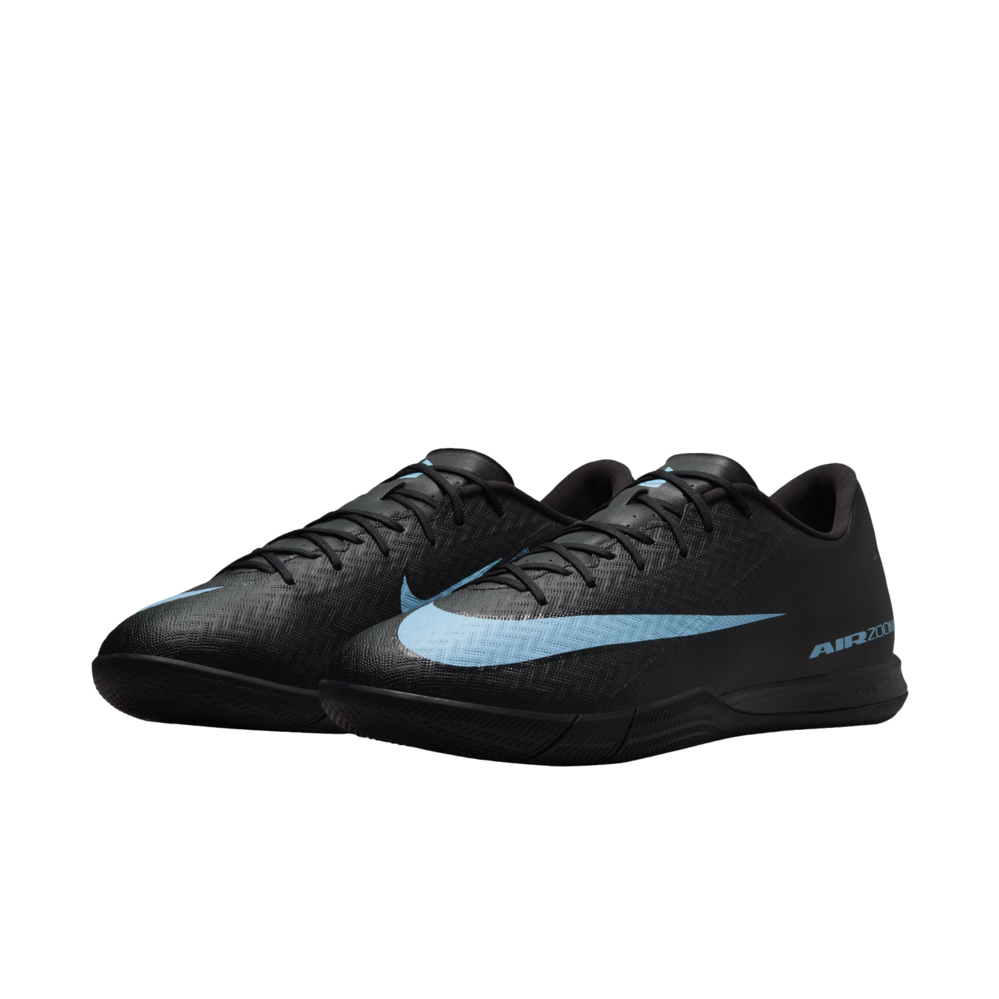 Pair of black Nike indoor soccer shoes featuring light blue swooshes and "AIR ZOOM" branding, displayed against a solid black background.