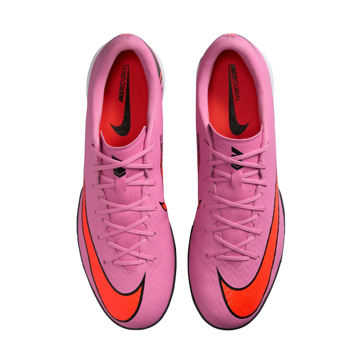 Top-down view of pink Nike Mercurial soccer shoes with orange swooshes on a black background.