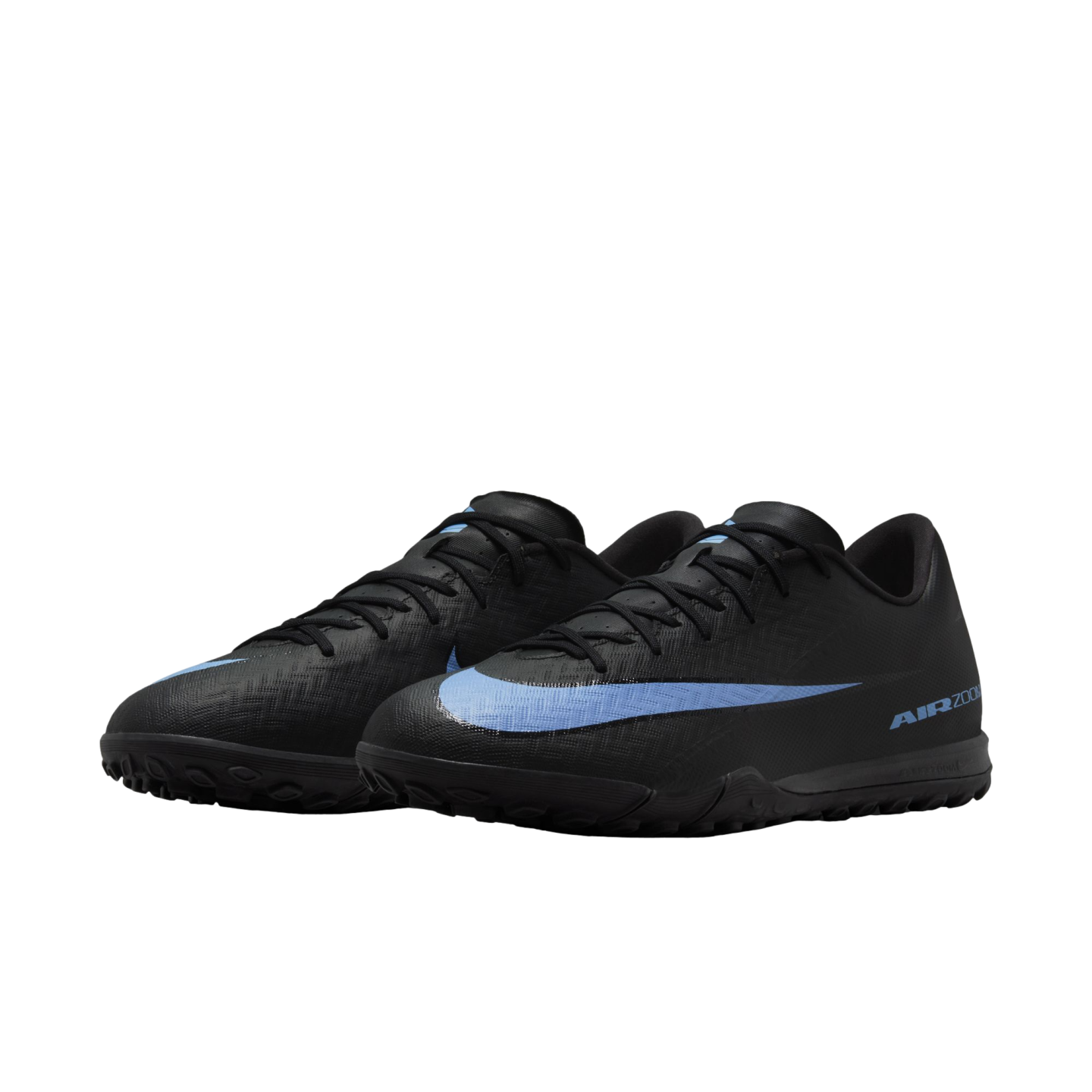 A pair of black Nike turf soccer shoes with a light blue swoosh and "AIR ZOOM" branding, set against a black background.