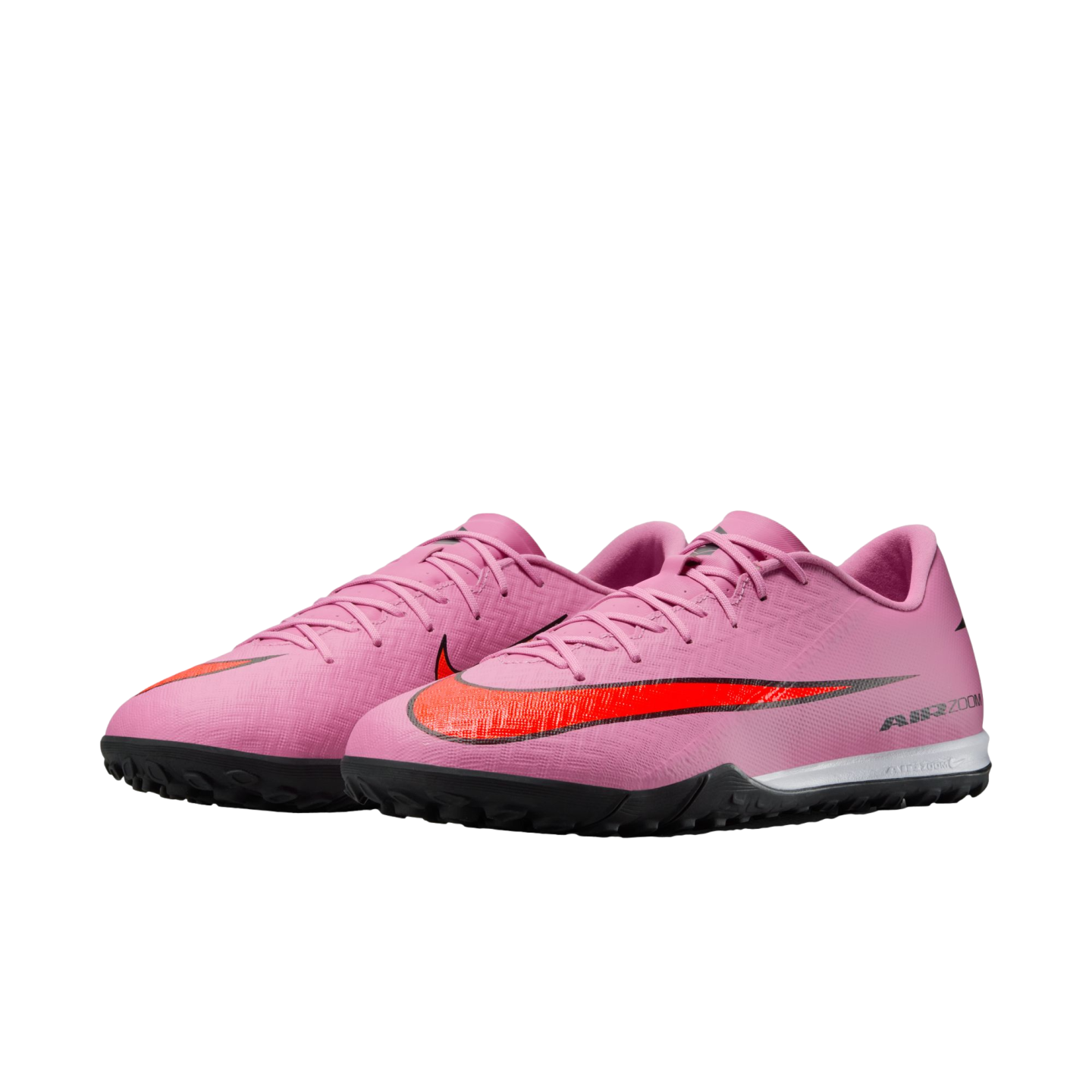 A pair of pink Nike Air Zoom turf soccer shoes featuring a bright red swoosh and black textured soles.