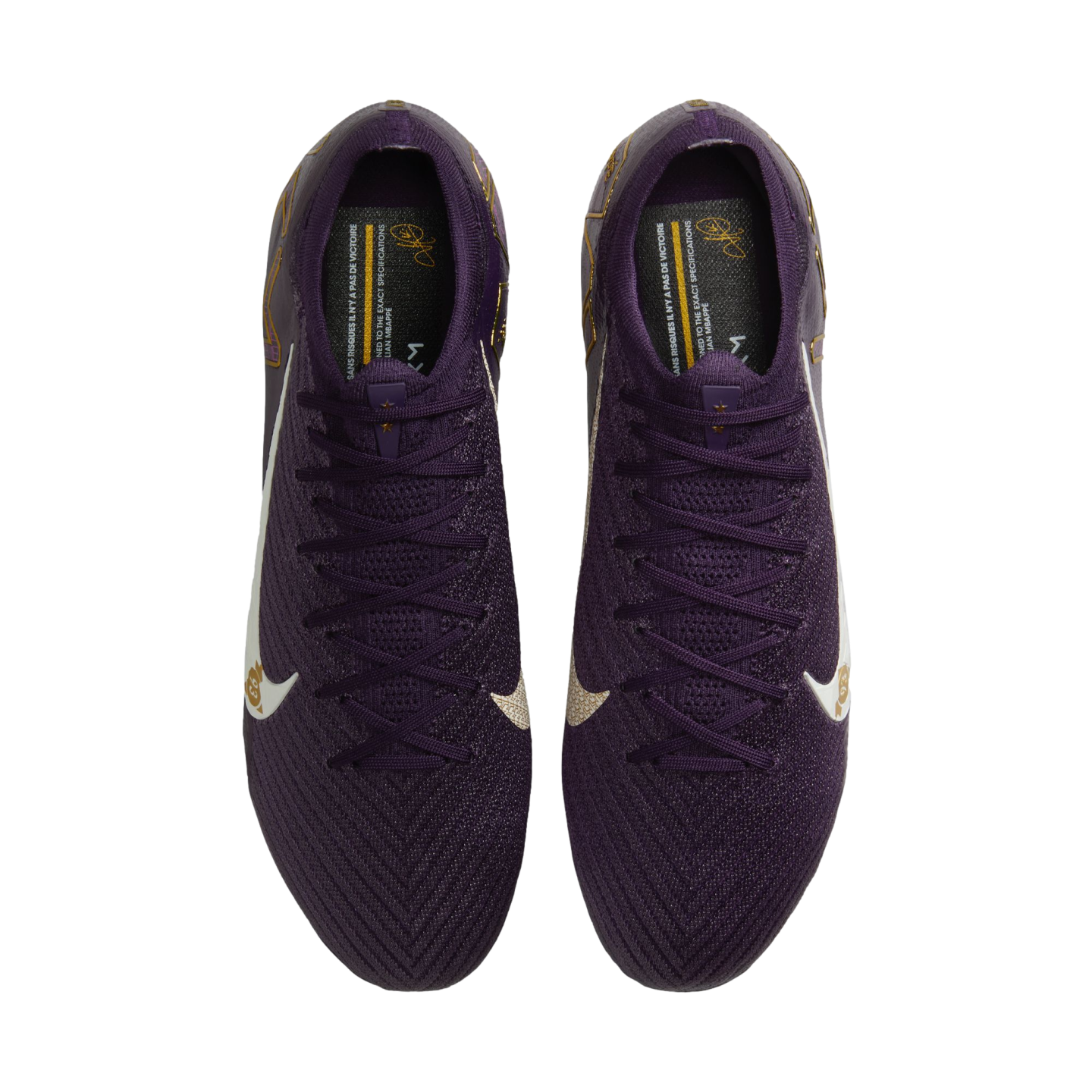 Top-down view of a pair of deep purple Nike football boots featuring white swooshes and gold accents on a plain white background.