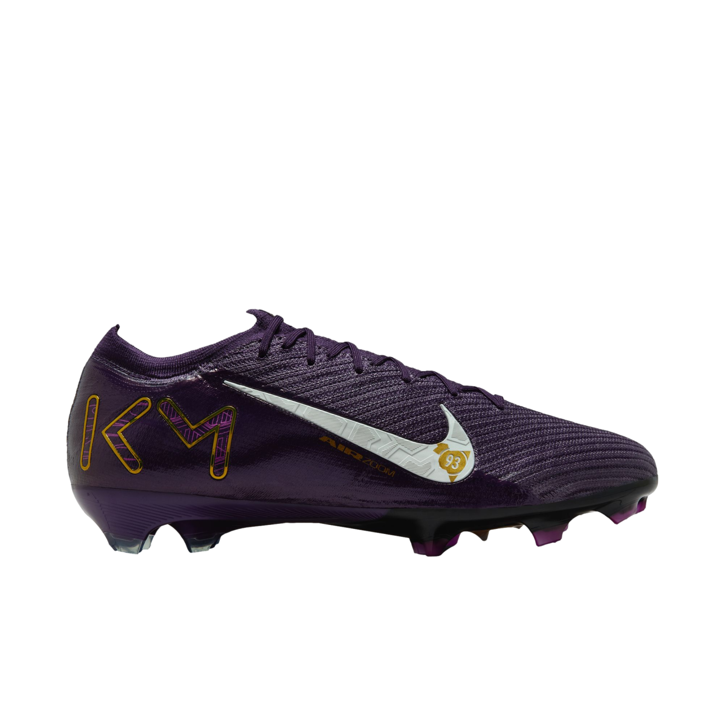 A dark purple Nike soccer cleat with gold "KM" branding on the heel, a white textured swoosh, and gold accents against a plain white background.