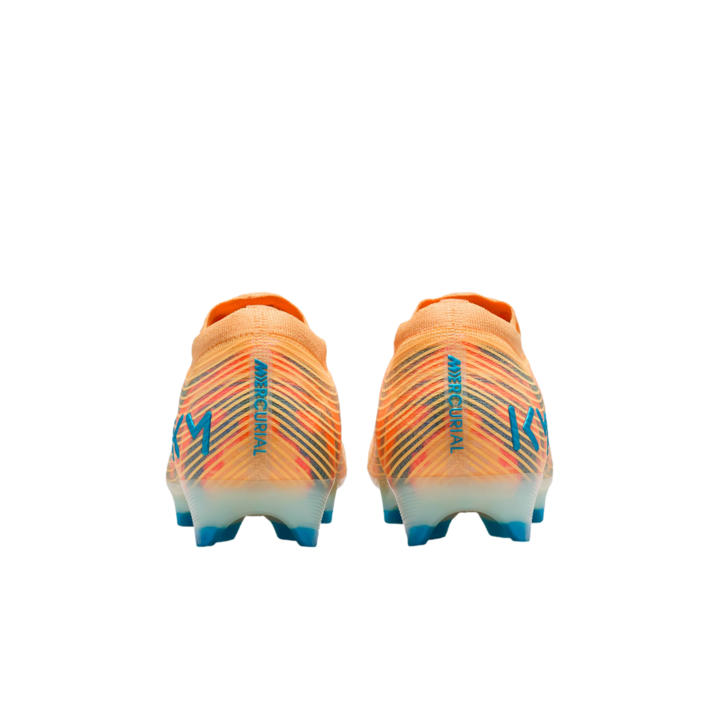Rear view of two orange Nike Mercurial soccer cleats featuring blue vertical text and "KM" logos on the heels against a black background.