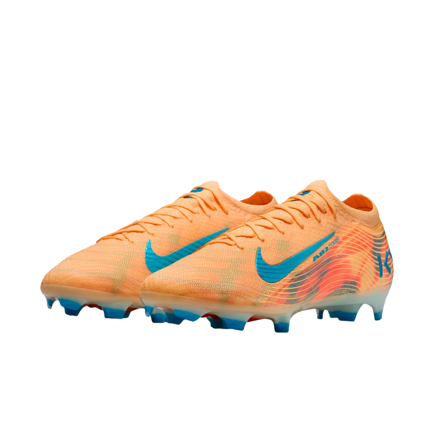 A pair of orange Nike soccer cleats with blue accents and studs against a black background.