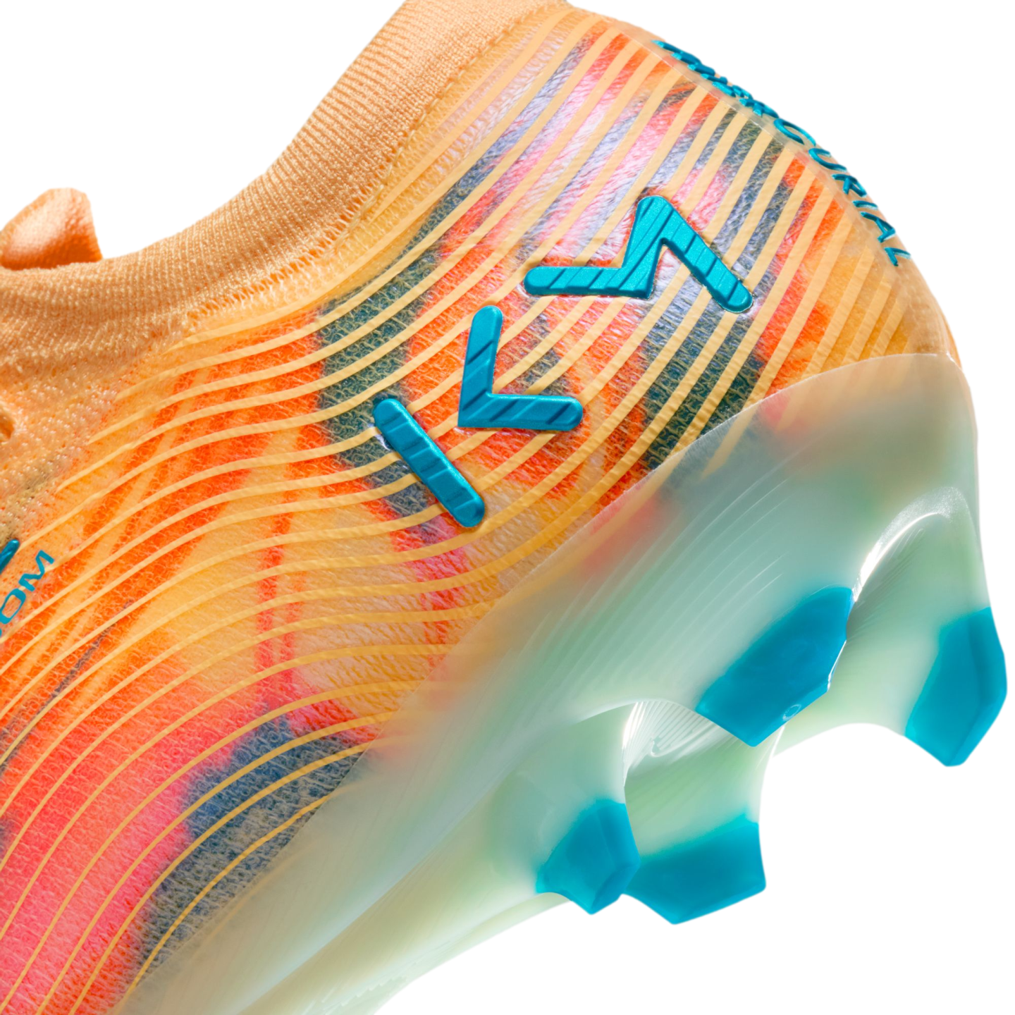 Close-up of an orange and pink soccer cleat featuring blue "KM" branding and blue studs on a translucent sole.