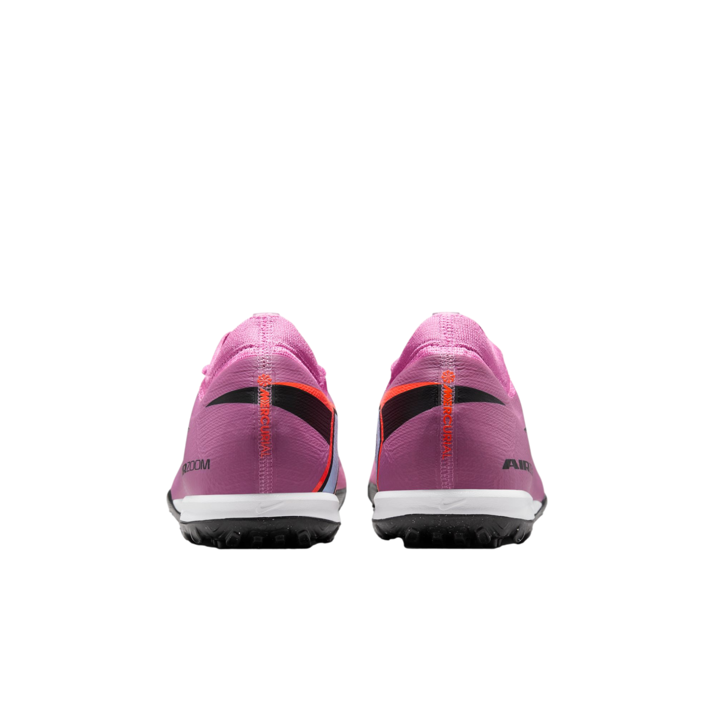 Rear view of pink Nike Mercurial turf shoes with white midsoles and black studded outsoles against a black background.