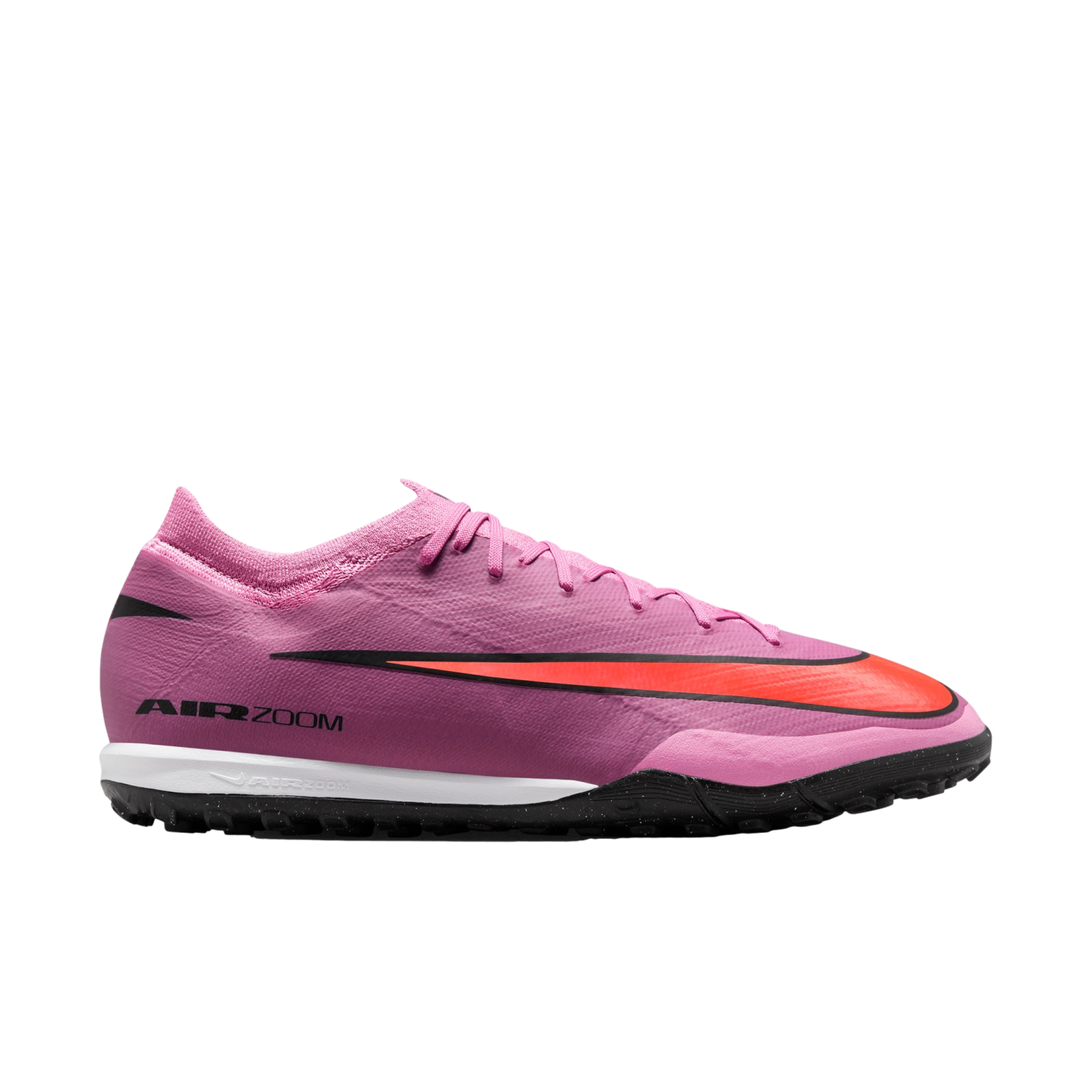 A pink Nike Air Zoom turf soccer shoe with a large orange swoosh, shown in a side profile against a black background.