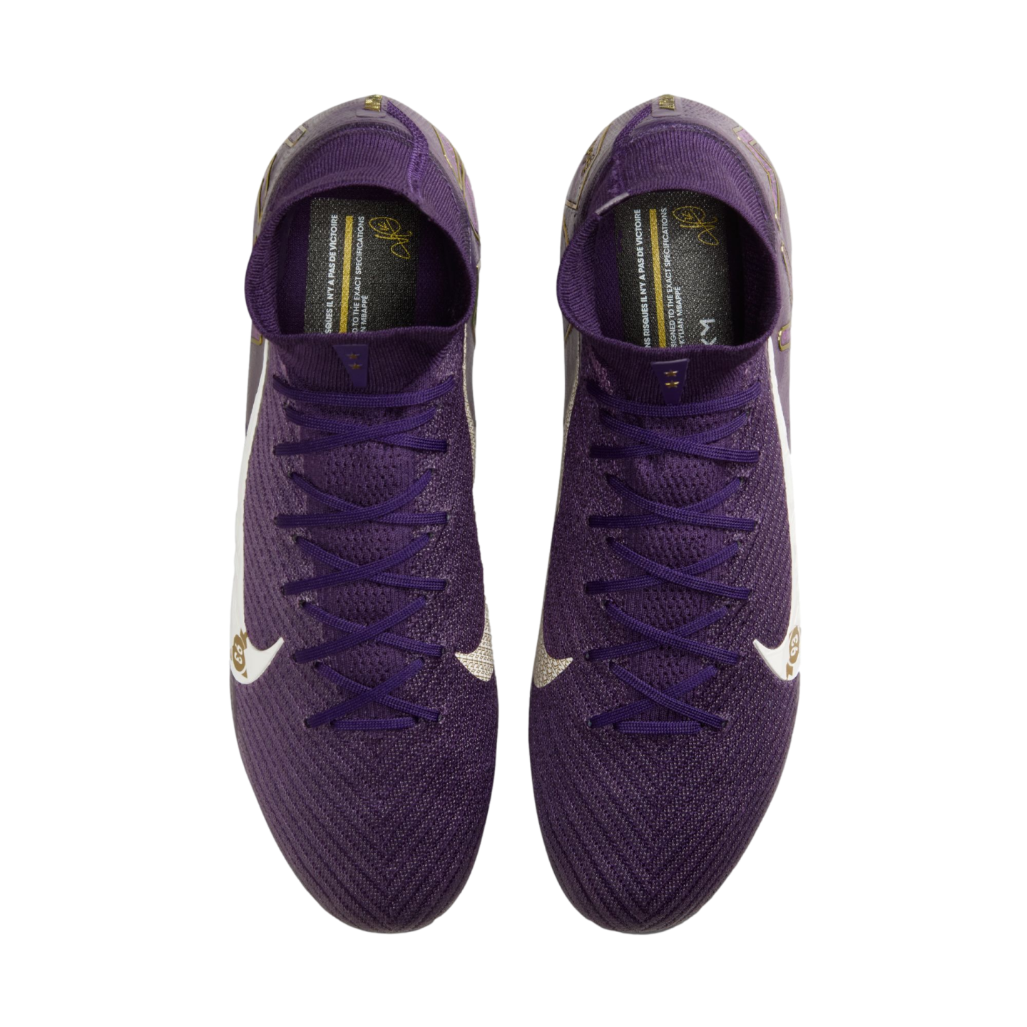 Top-down view of purple Nike soccer cleats with white swooshes and gold accents on a white background.