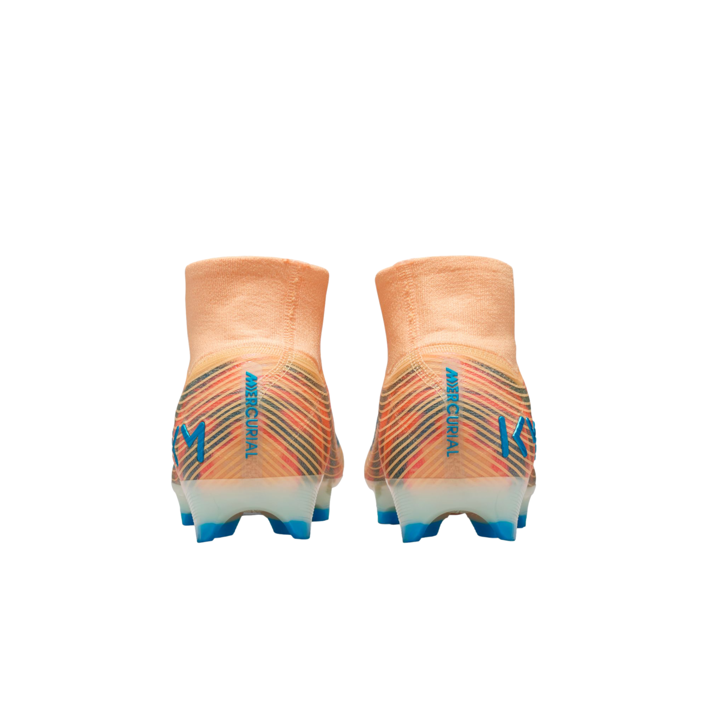 Back view of two orange Nike Mercurial soccer cleats with blue "KM" logos and colorful striped heels against a black background.