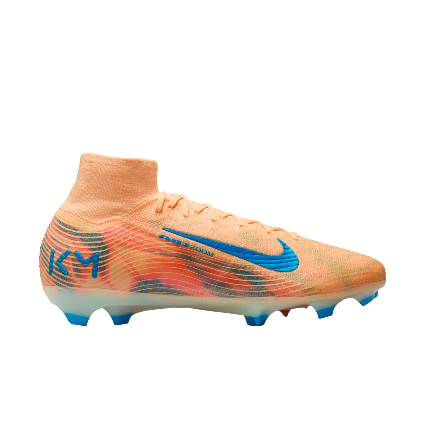 A peach Nike soccer cleat with a colorful graphic pattern, a blue swoosh, and blue "KM" branding on the heel, set against a solid black background.