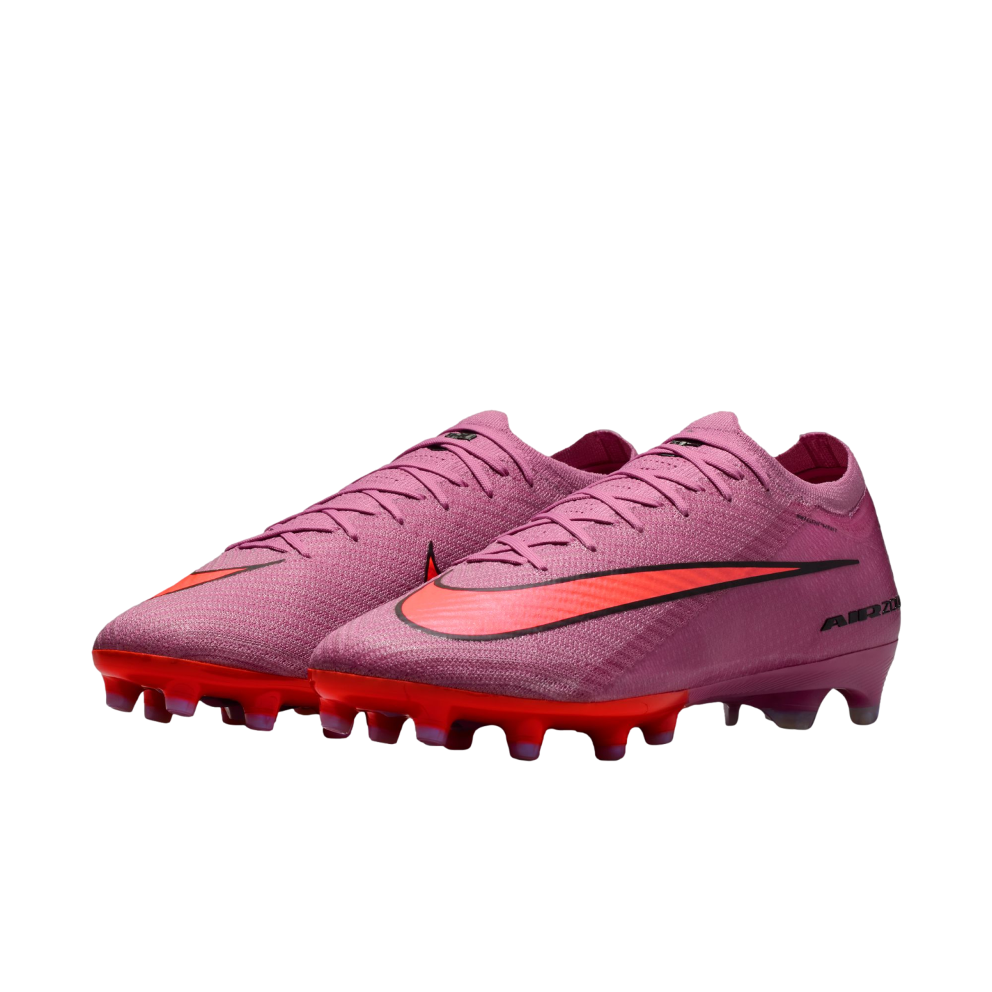 A pair of purple Nike Air Zoom soccer cleats with bright orange Nike swooshes and orange studded soles, set against a solid black background.