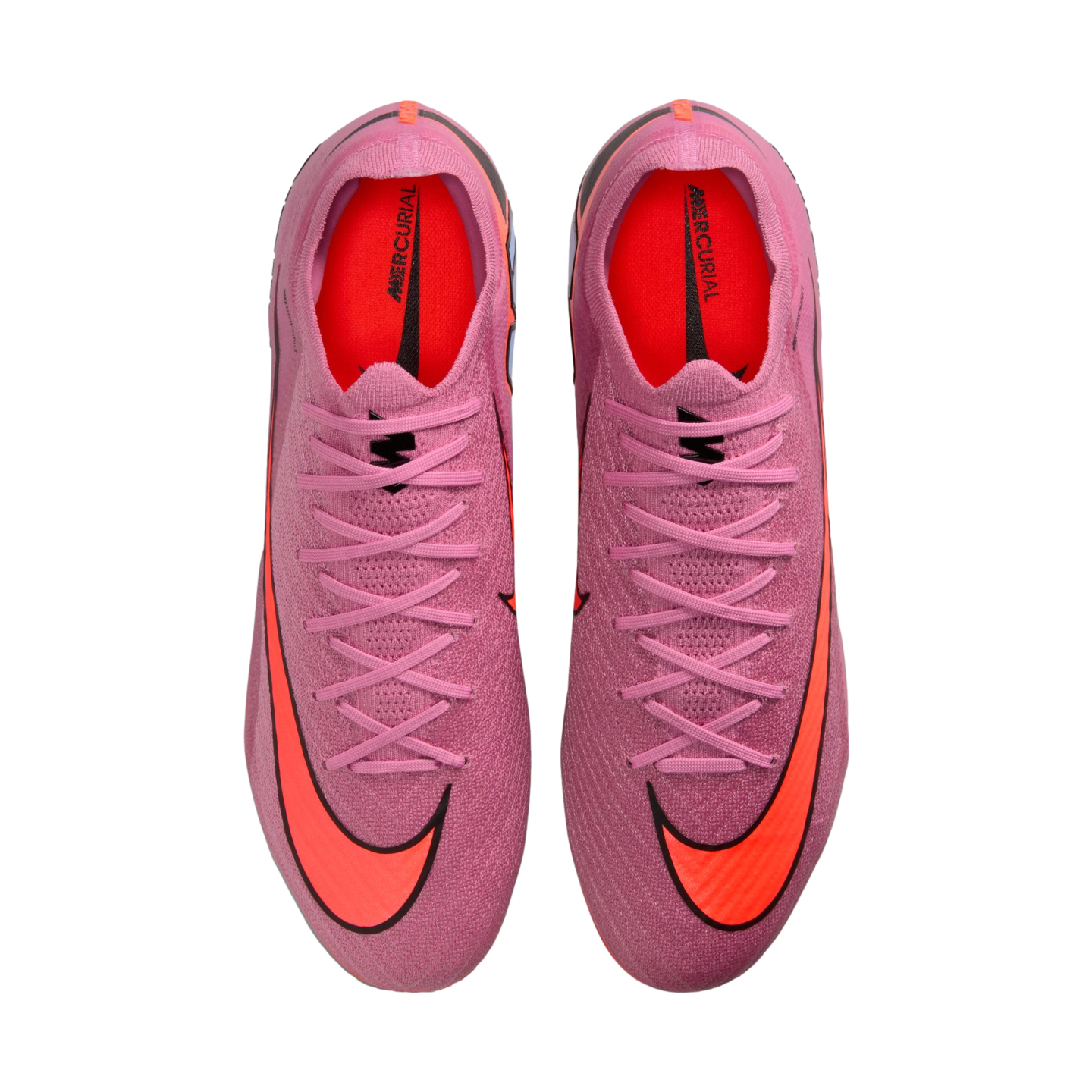 Top-down view of pink Nike Mercurial soccer cleats featuring bright orange Nike swooshes and interior padding, set against a black background.